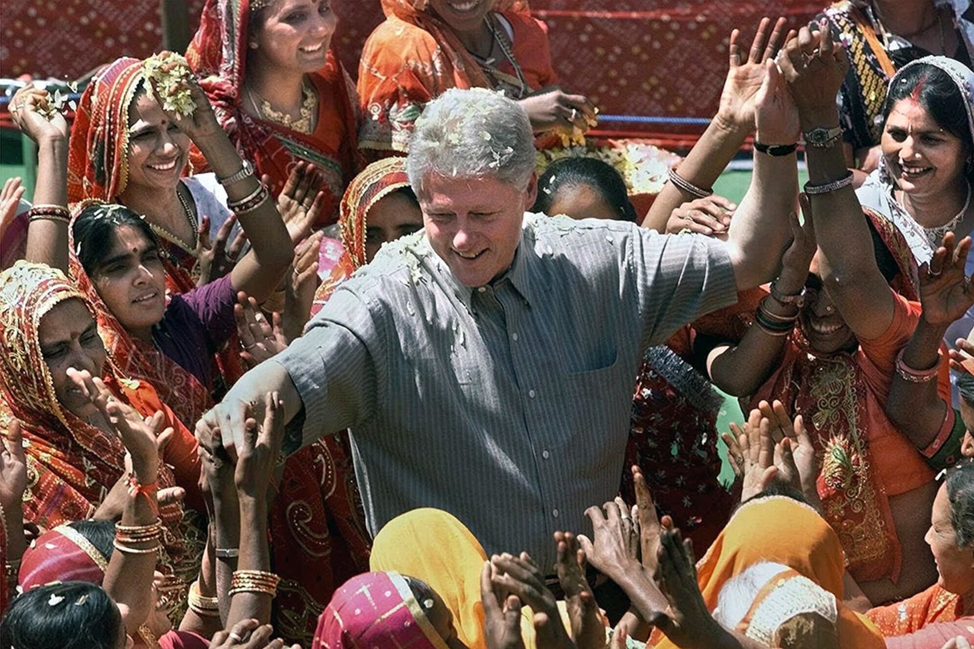 President Clinton reaches out to residents of Nayla, India. J. Scott Applewhite/Reuters