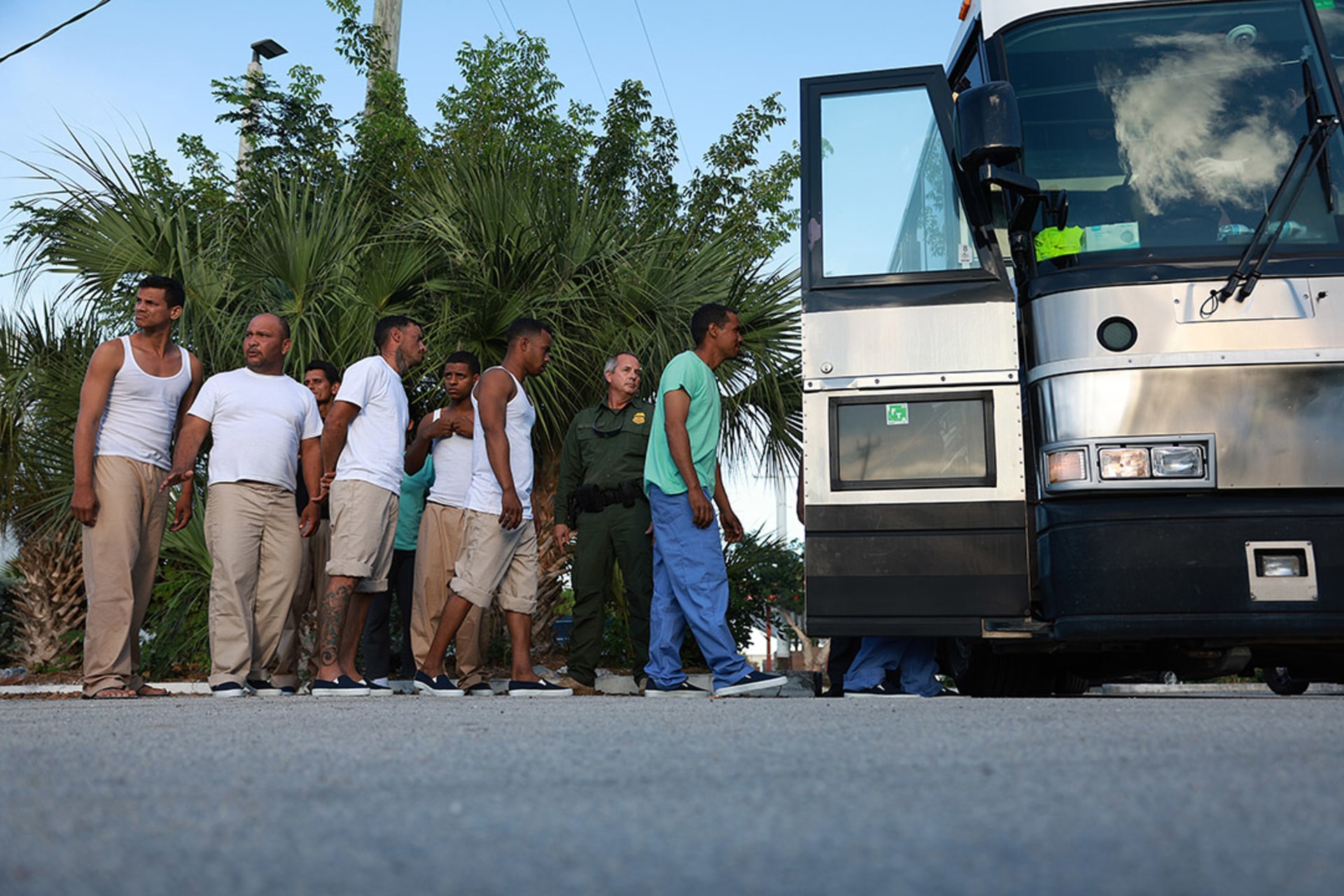 A group of Cuban migrants boards a bus that will take them to a U.S. Customs and Border Protection station to be processed in Marathon, Florida. 