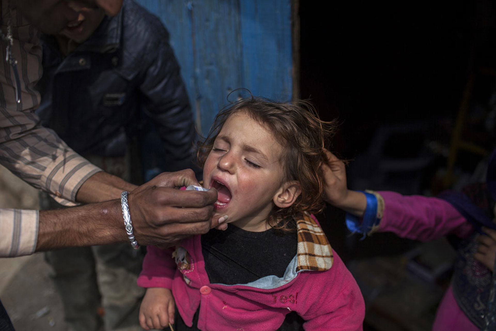 A health worker gives polio vaccine drops to a child in Islamabad, Pakistan, in February 2014. Sara Farid/Reuters