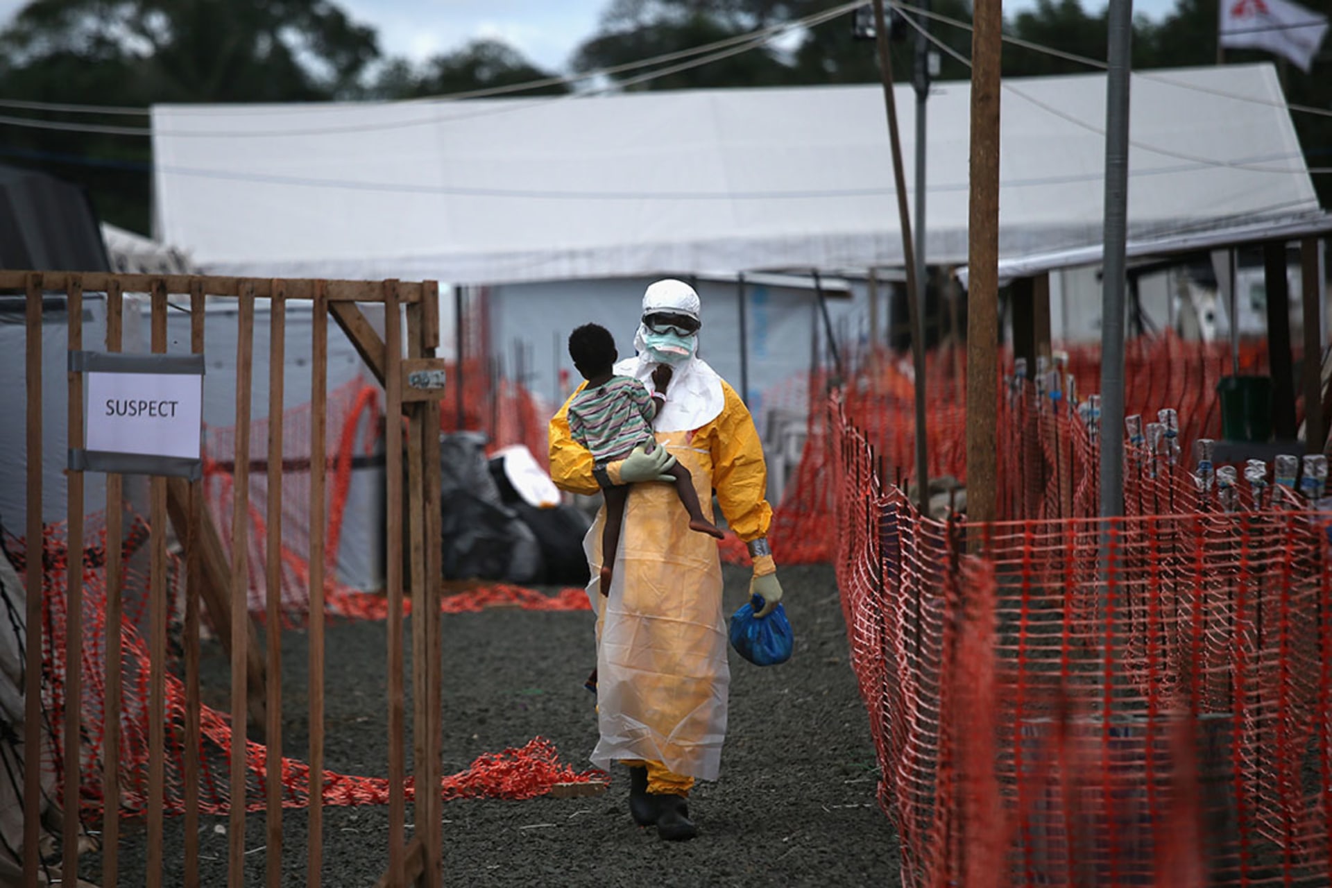A Doctors Without Borders worker carries a child suspected of having Ebola at a treatment center in Paynesville, Liberia, in October 2014. John Moore/Getty Images