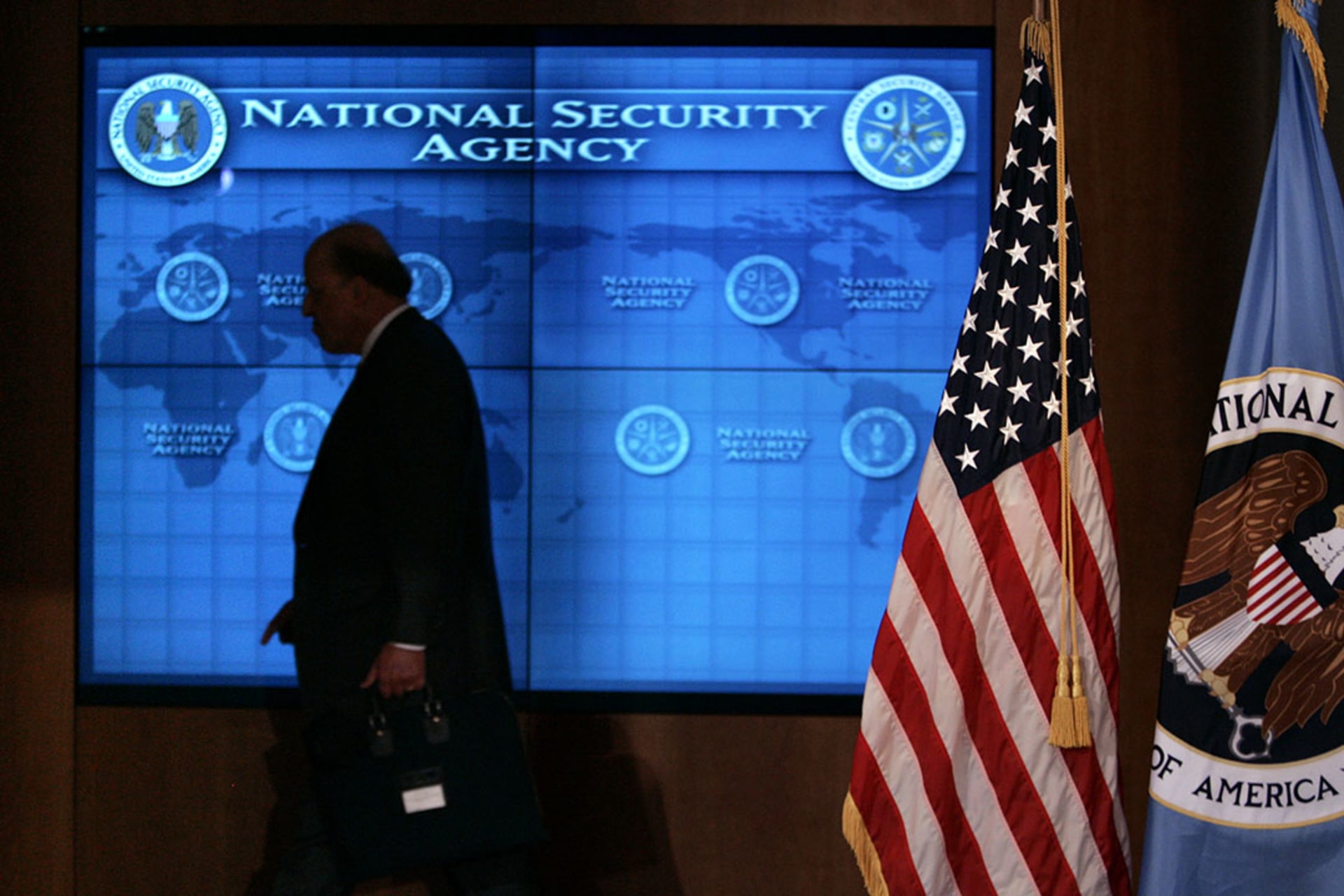 U.S. Director of National Intelligence John Negroponte walks past a video screen during a visit by President Bush to the NSA at Fort Meade, Maryland. Brooks Kraft LLC/Corbis/Getty Images