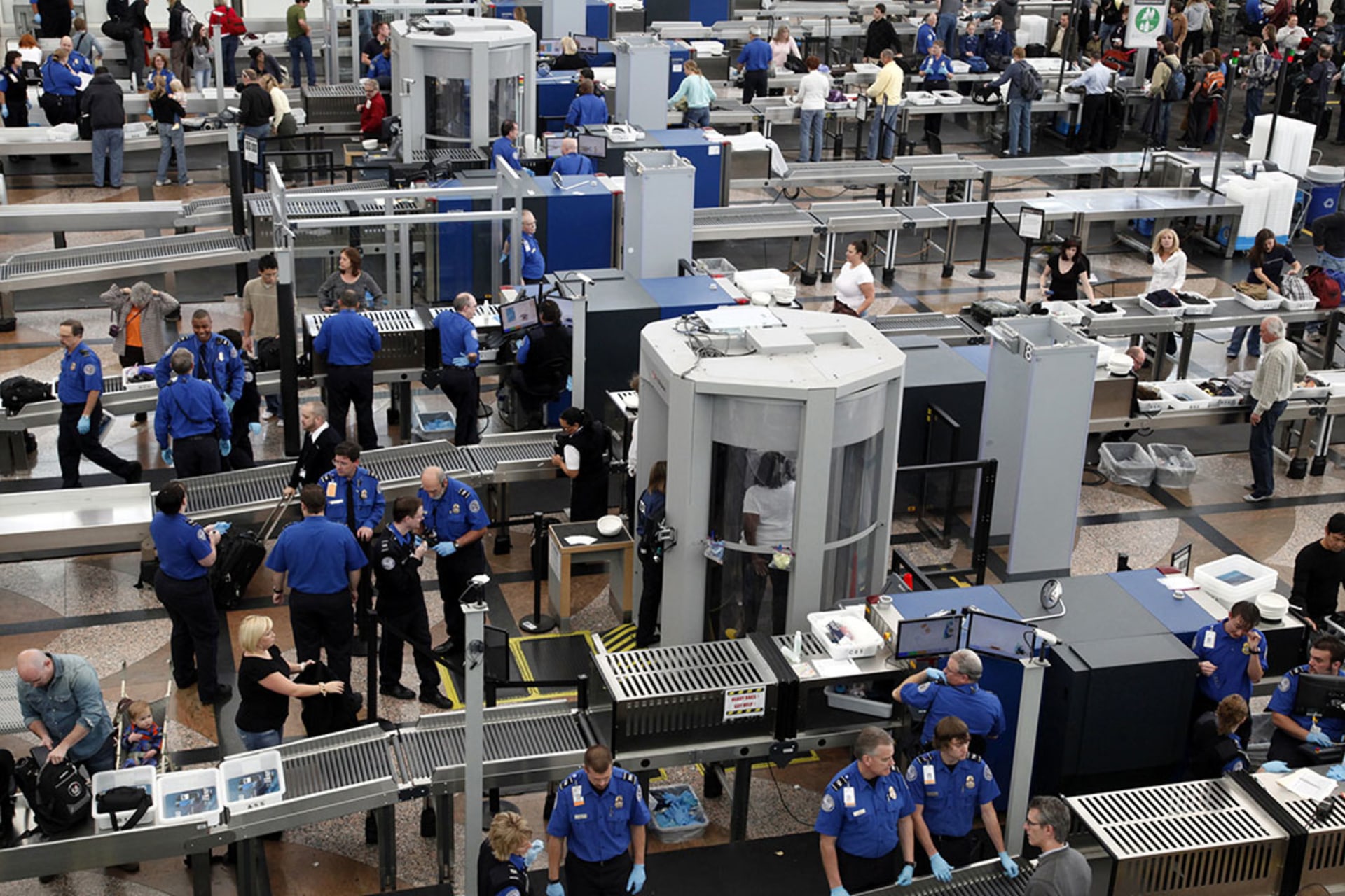 TSA workers conduct security checks, including full-body scans, at a crowded Denver International Airport. Rick Wilking/Reuters