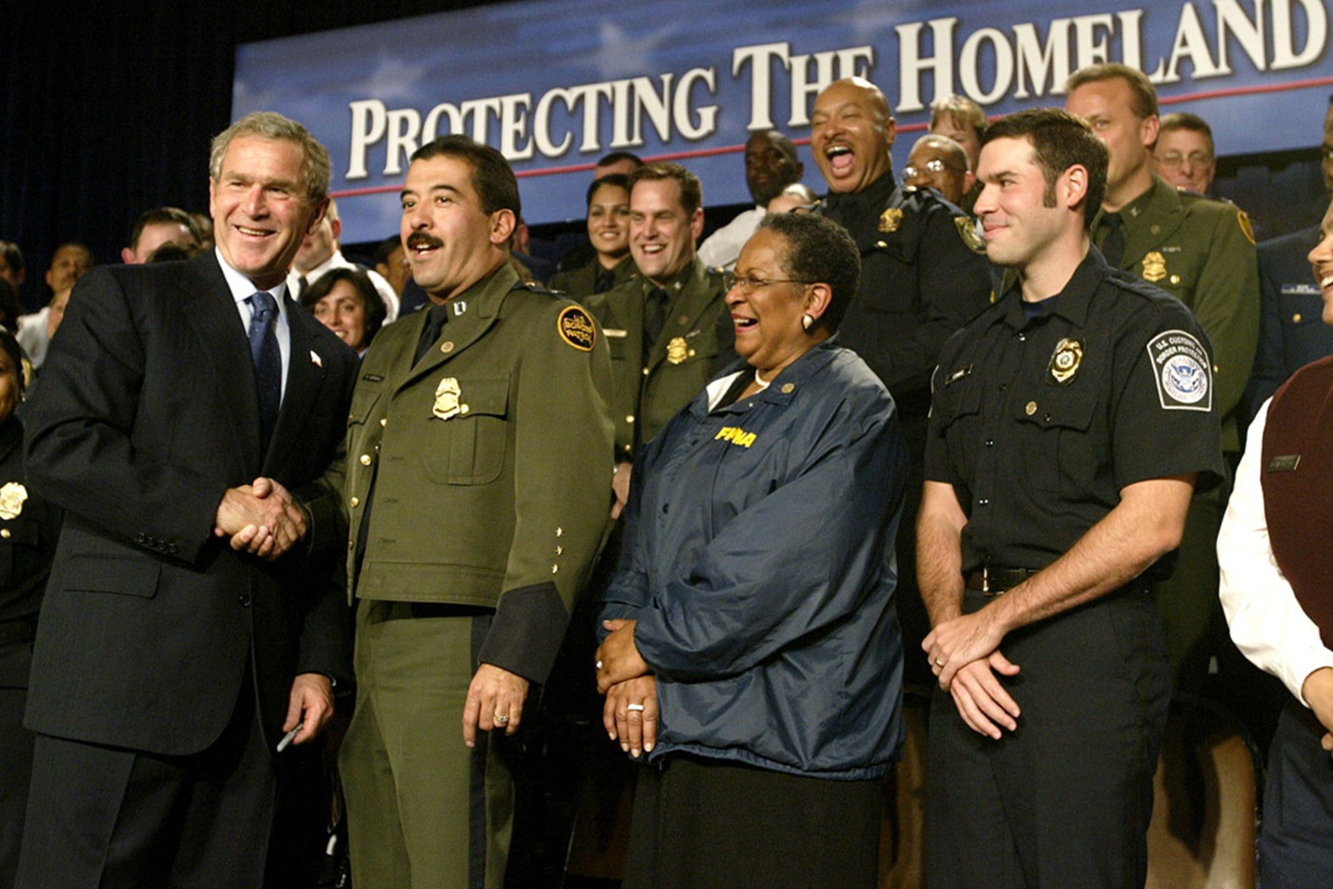 Bush greets U.S. Border Patrol officers at an event promoting the Department of Homeland Security. Jason Reed/Reuters