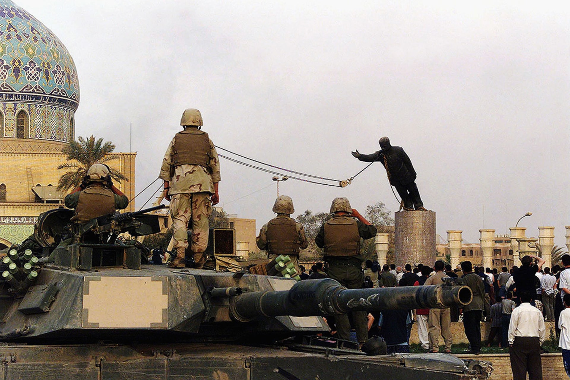 U.S. forces watch as Iraqis topple the statue of Saddam Hussein in Baghdad’s Firdos Square in April 2003. Wathiq Khuzaie/Getty Images