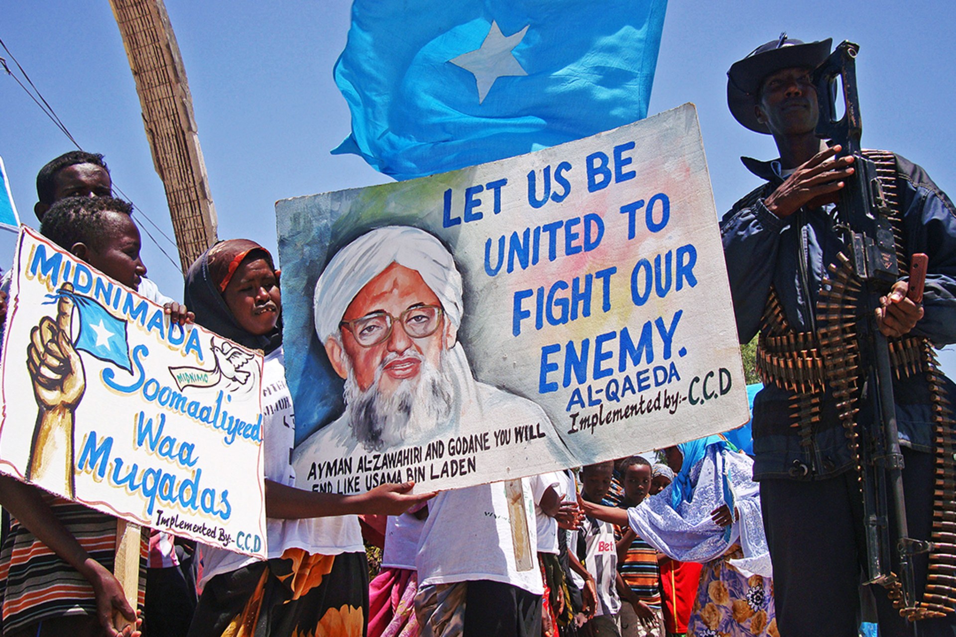 Demonstrators in Mogadishu hold posters opposing al-Shabaab’s announcement that it will join the al-Qaeda network. Mohamed Abdiwahab/AFP/Getty Images
