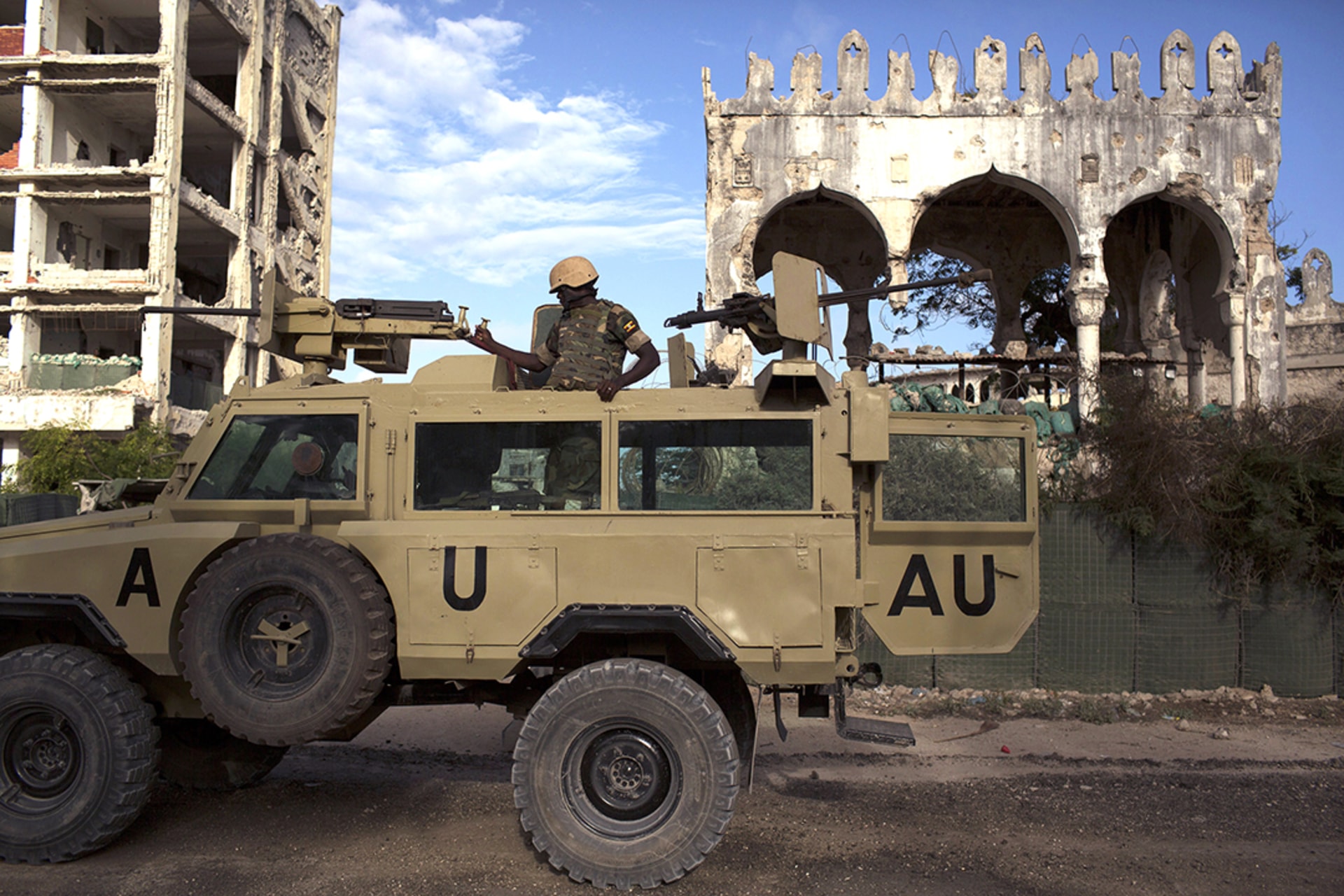 An AMISOM soldier keeps guard on top of an armored vehicle in Mogadishu. Siegfried Modola/Reuters