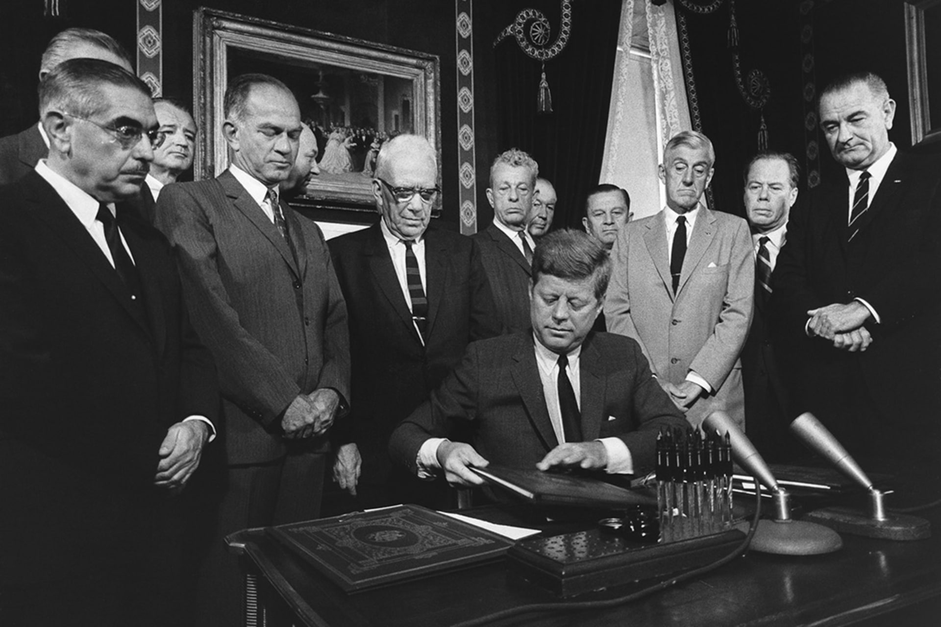 President John F. Kennedy prepares to sign the Limited Test Ban Treaty with the Soviet Union in 1963. 
