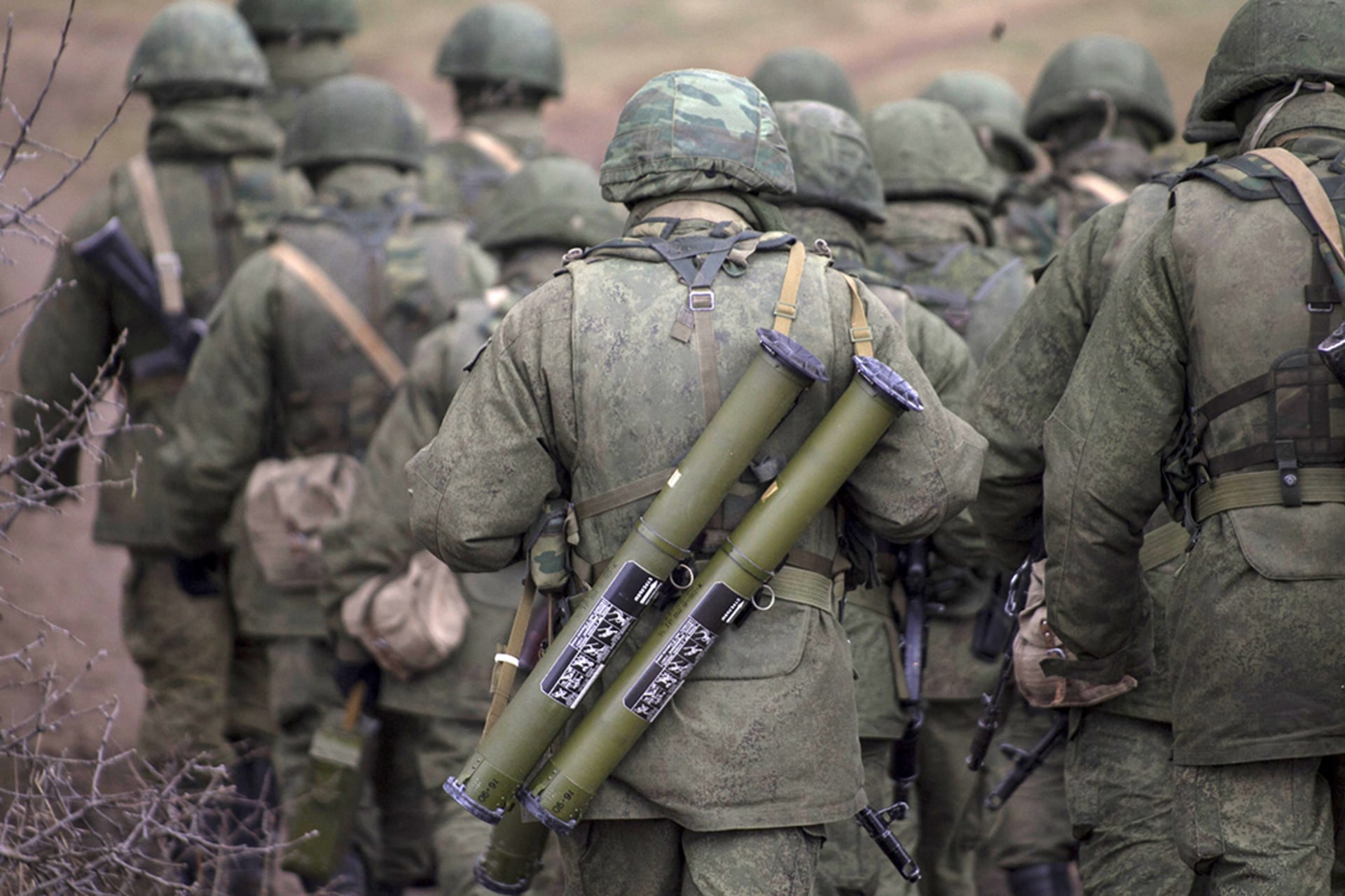A Russian serviceman carries two rocket launchers near the Crimean city of Simferopol, March 2014. 
