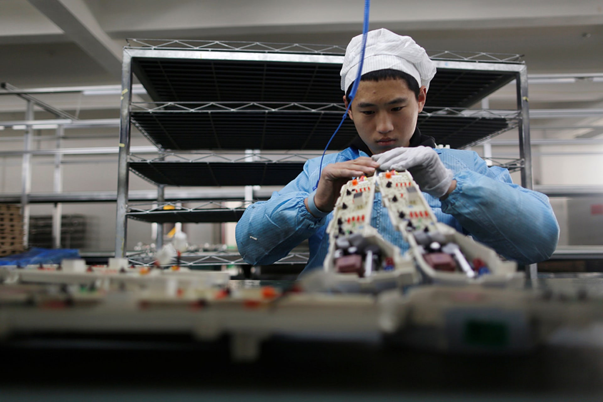 A person works in an electronics factory in Qingdao. 

