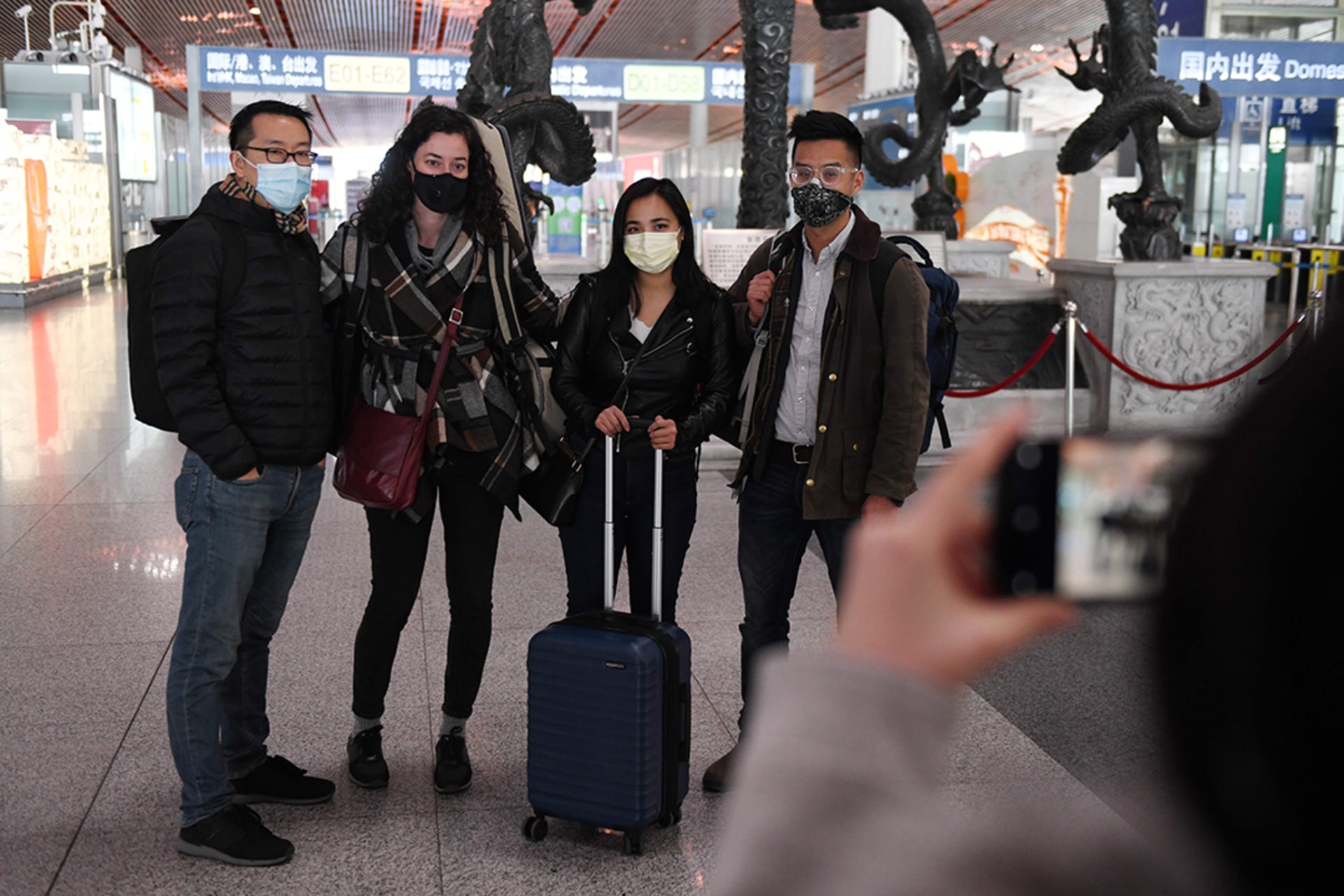 Wall Street Journal reporters pose for a photo before departing from Beijing Capital International Airport. 
