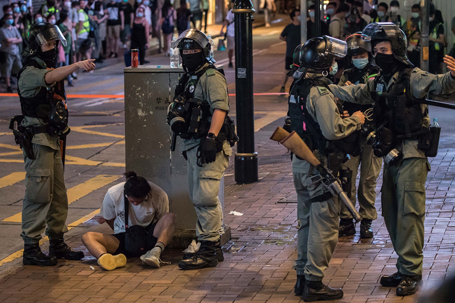 Riot police detain a man after clearing a protest against the new national security law in Hong Kong. 
