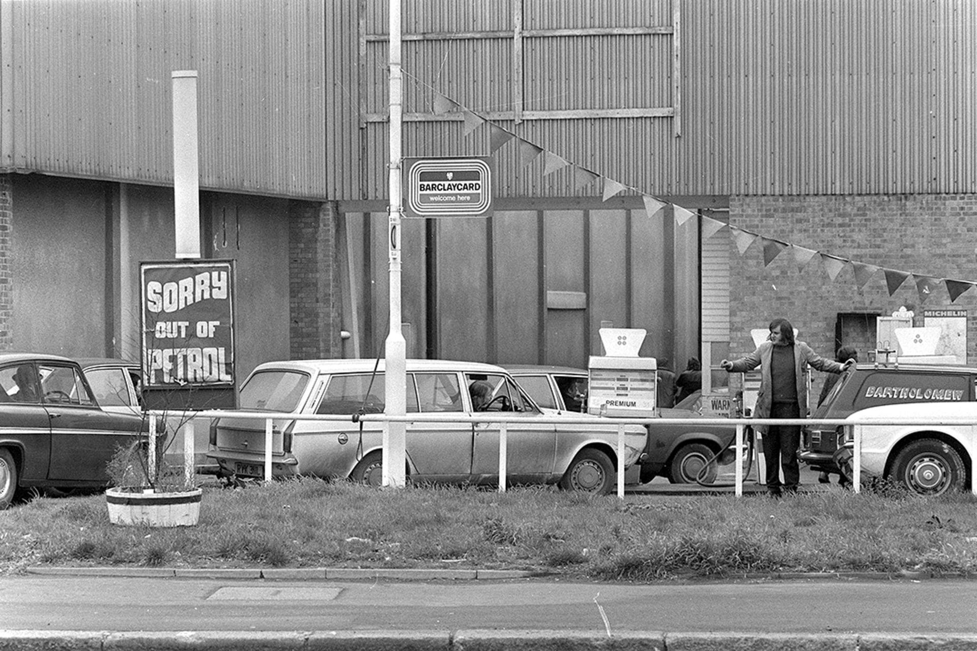 Cars line up for their ration of gas in Surrey, Britain, December 4, 1973.