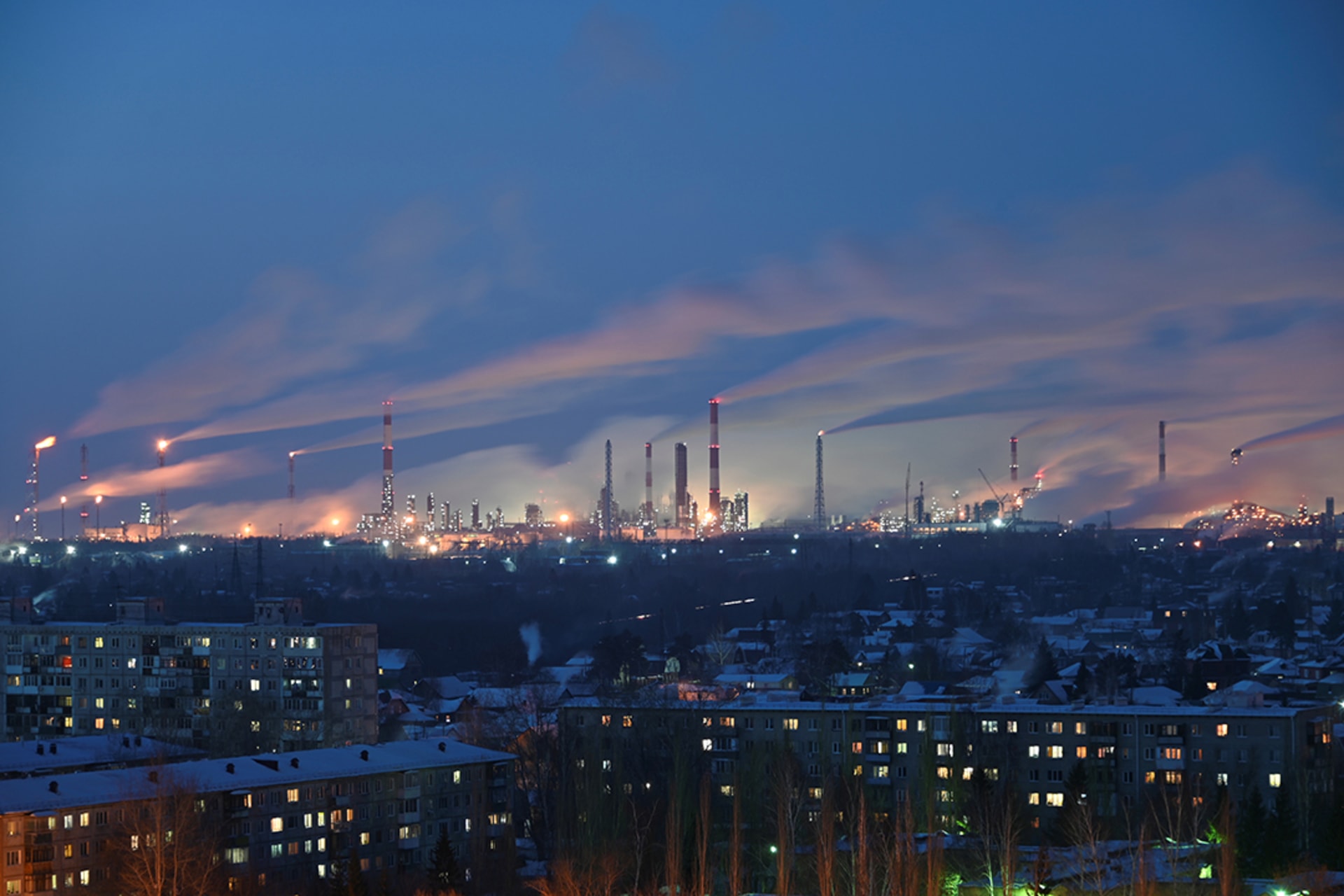 An oil refinery overlooks residential buildings in Omsk, Russia. 
