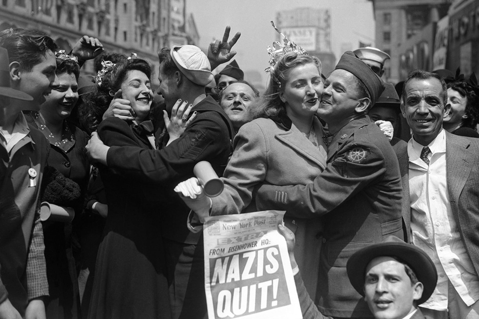 New Yorkers celebrate the surrender of Nazi Germany in Times Square. 

