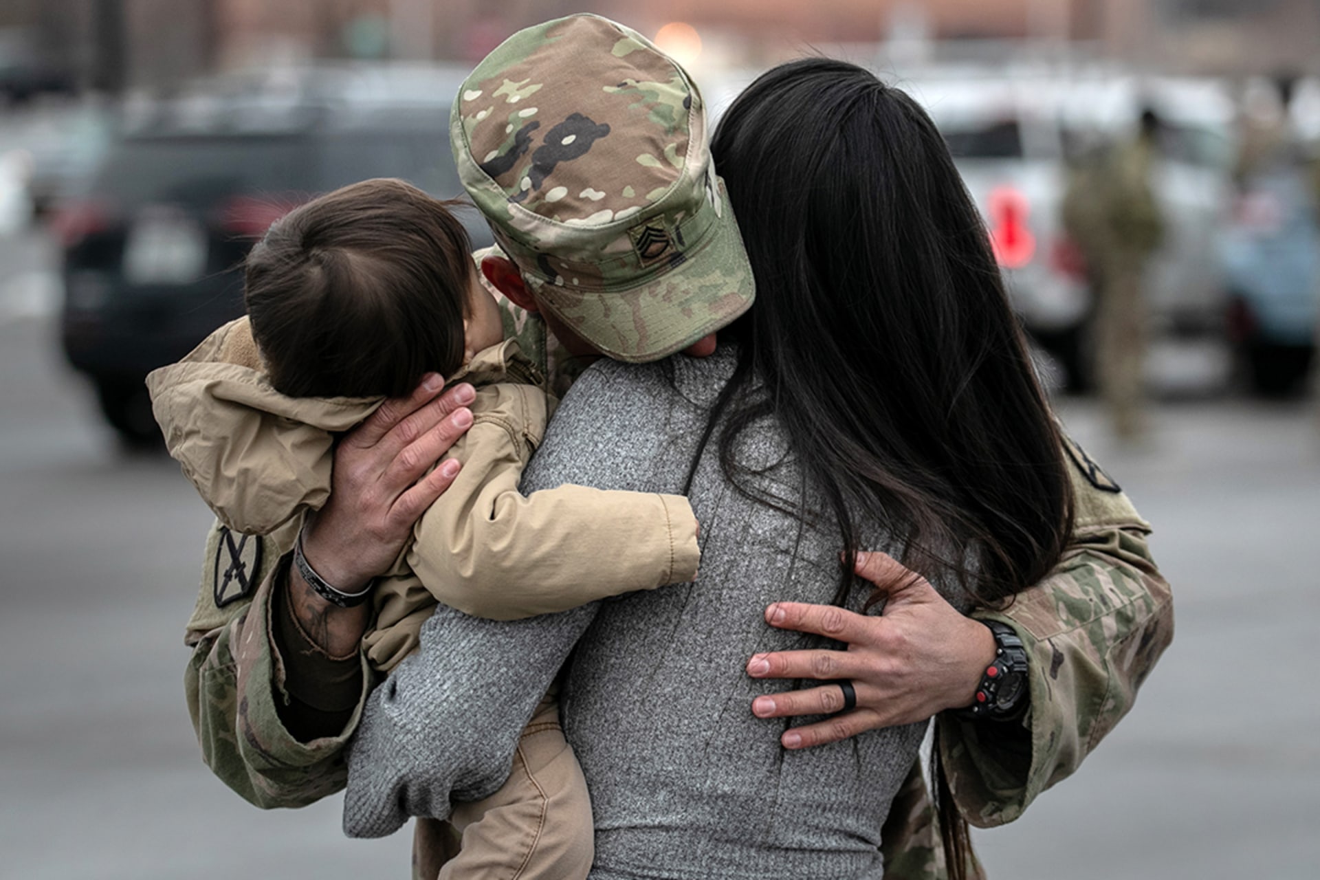 A U.S. soldier hugs his family after returning to the United States in December 2020 following his deployment in Afghanistan.