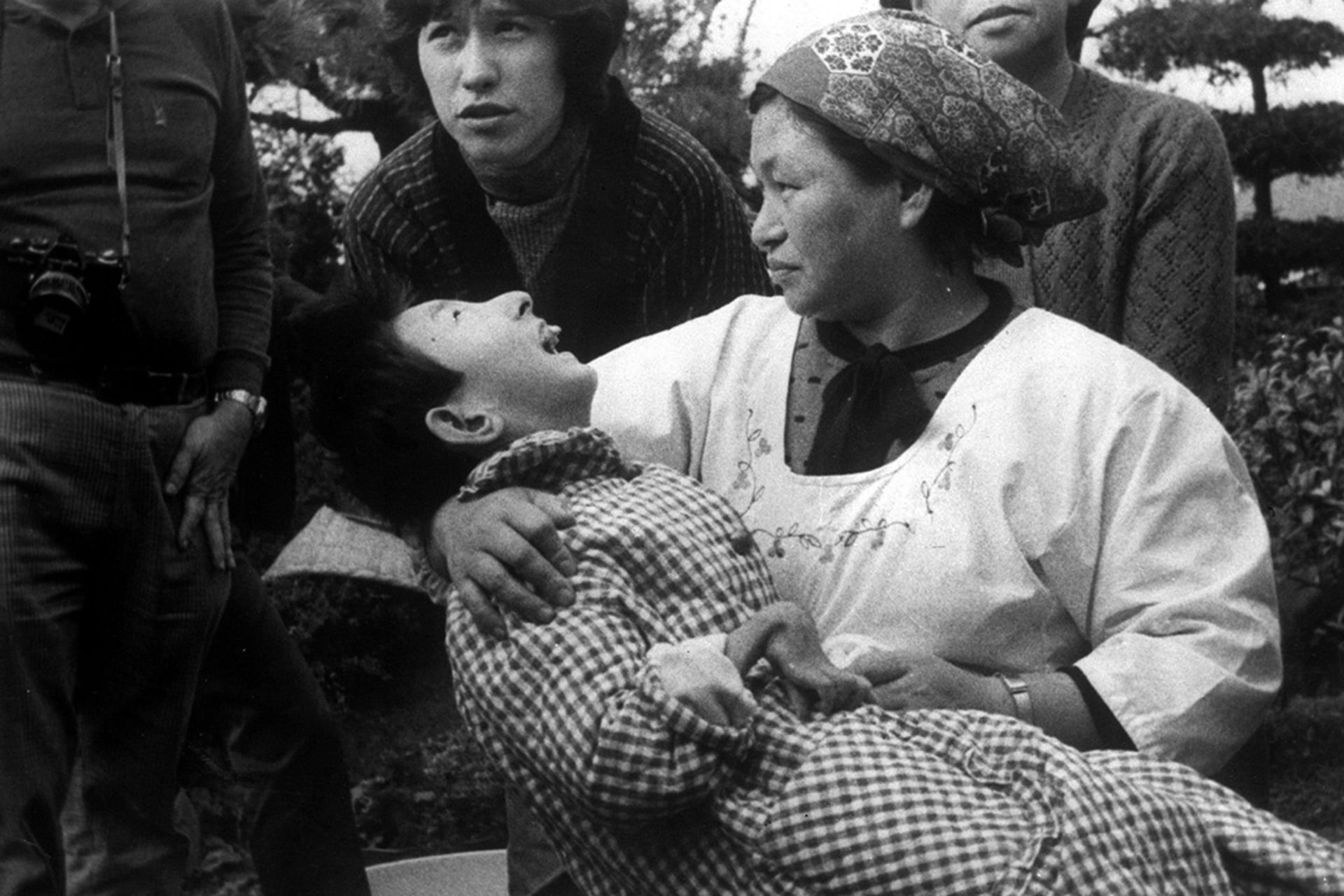 A woman holds a victim of Minamata disease in Minamata, Japan, in 1973.