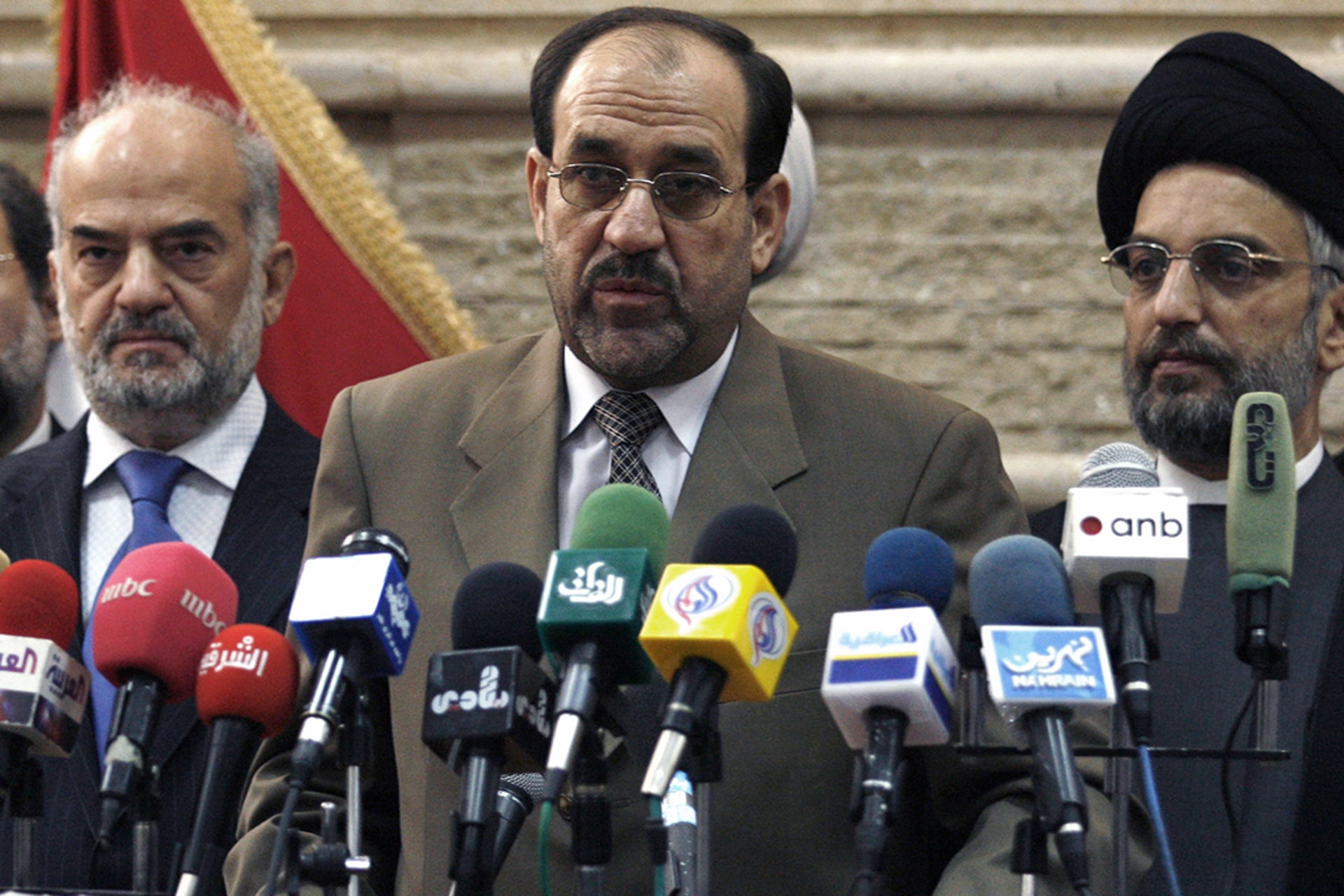 Iraqi politician Nouri al-Maliki is flanked by Prime Minister Ibrahim al-Jaafari on his left and Sunni Muslim leader Abdul Aziz al-Hakim on his right at a news conference. 
