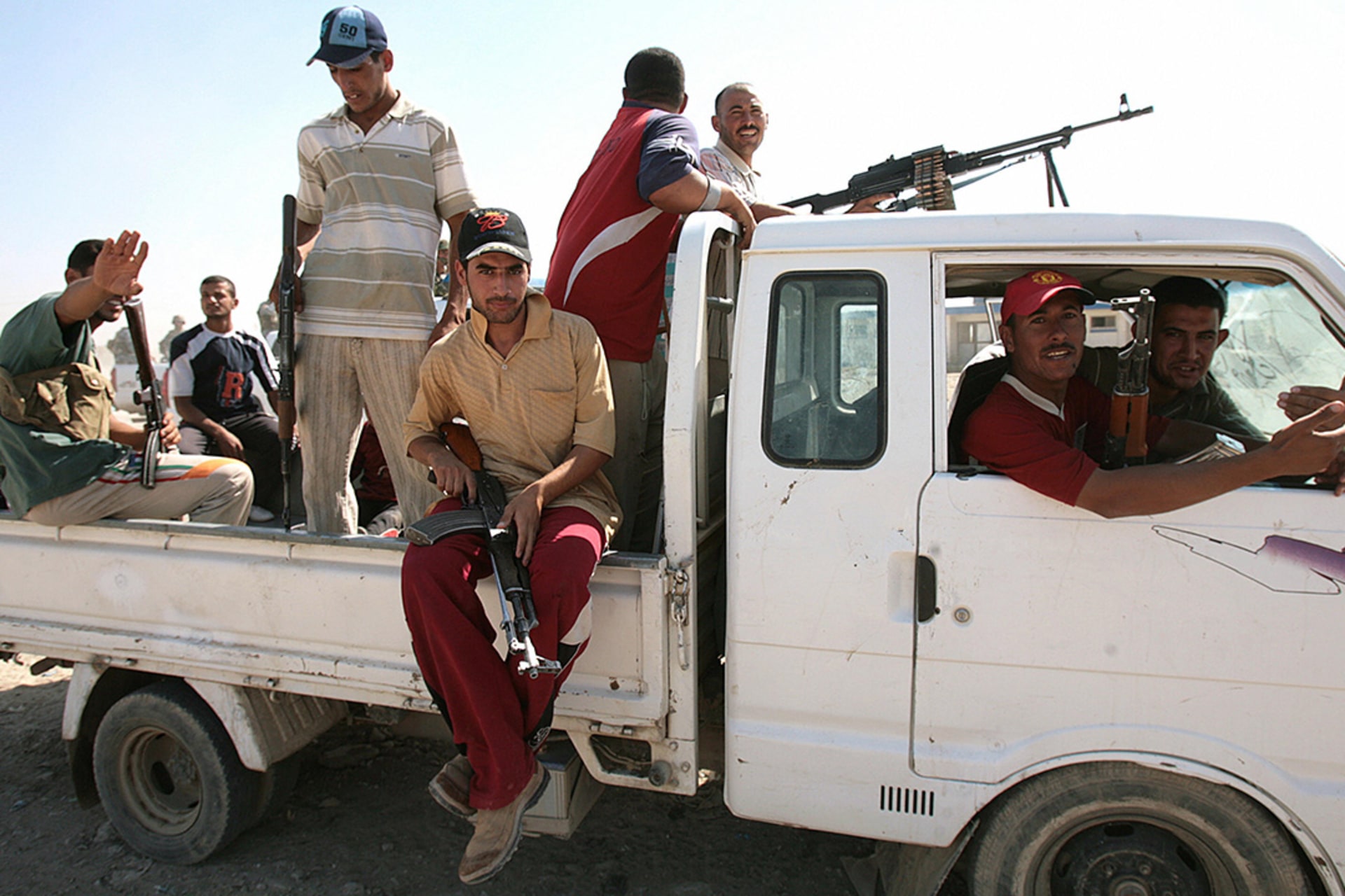 Former insurgents guard a meeting between Sunni and Shiite tribal leaders and clerics in al-Duwanem, southwest of Baghdad, in September 2007. 
