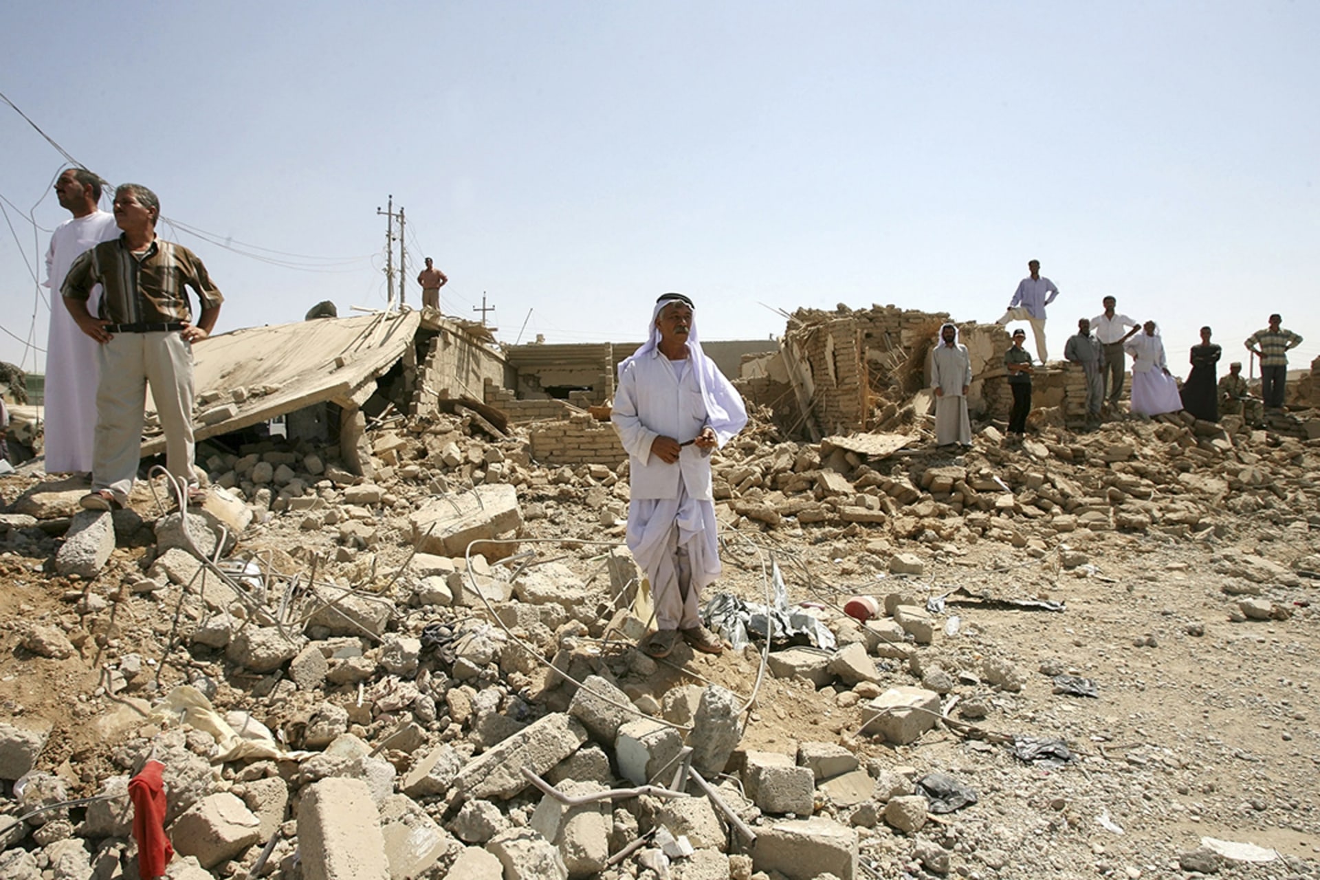 Men survey the site of a suicide bombing in Til Ezer, also known as Qahtaniya, one of two Yazidi villages attacked on August 14, 2007.