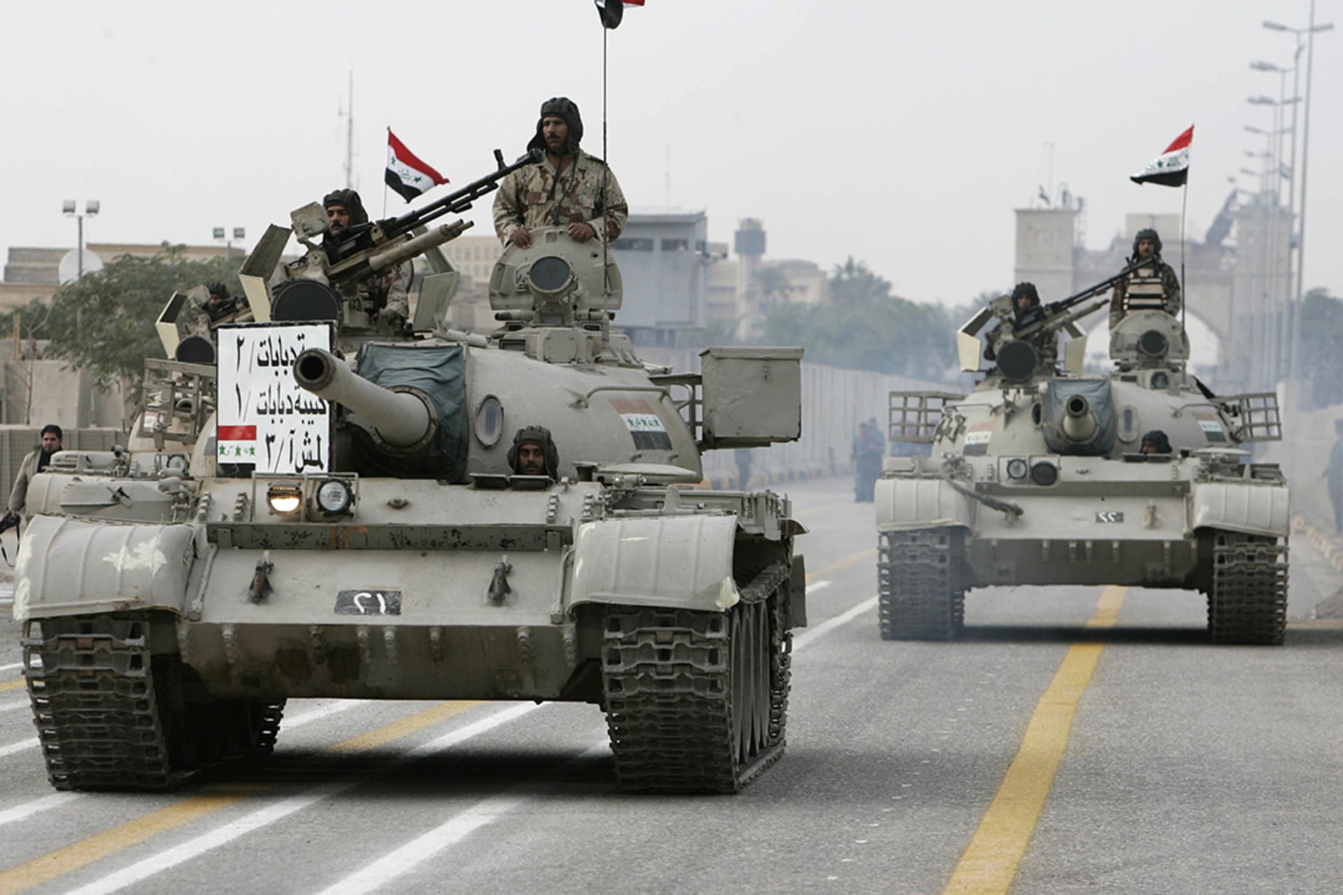 Iraqi soldiers drive tanks during a handover ceremony in the city of Basra. 
