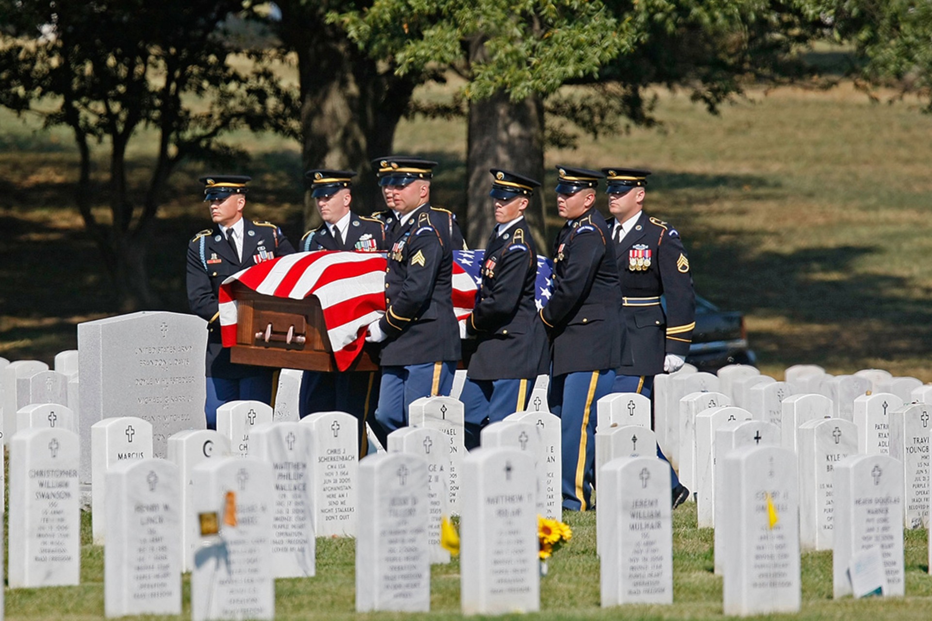 A military honor guard carries the casket of Army Sergeant Michael C. Hardegree during his funeral in Arlington, Virginia.