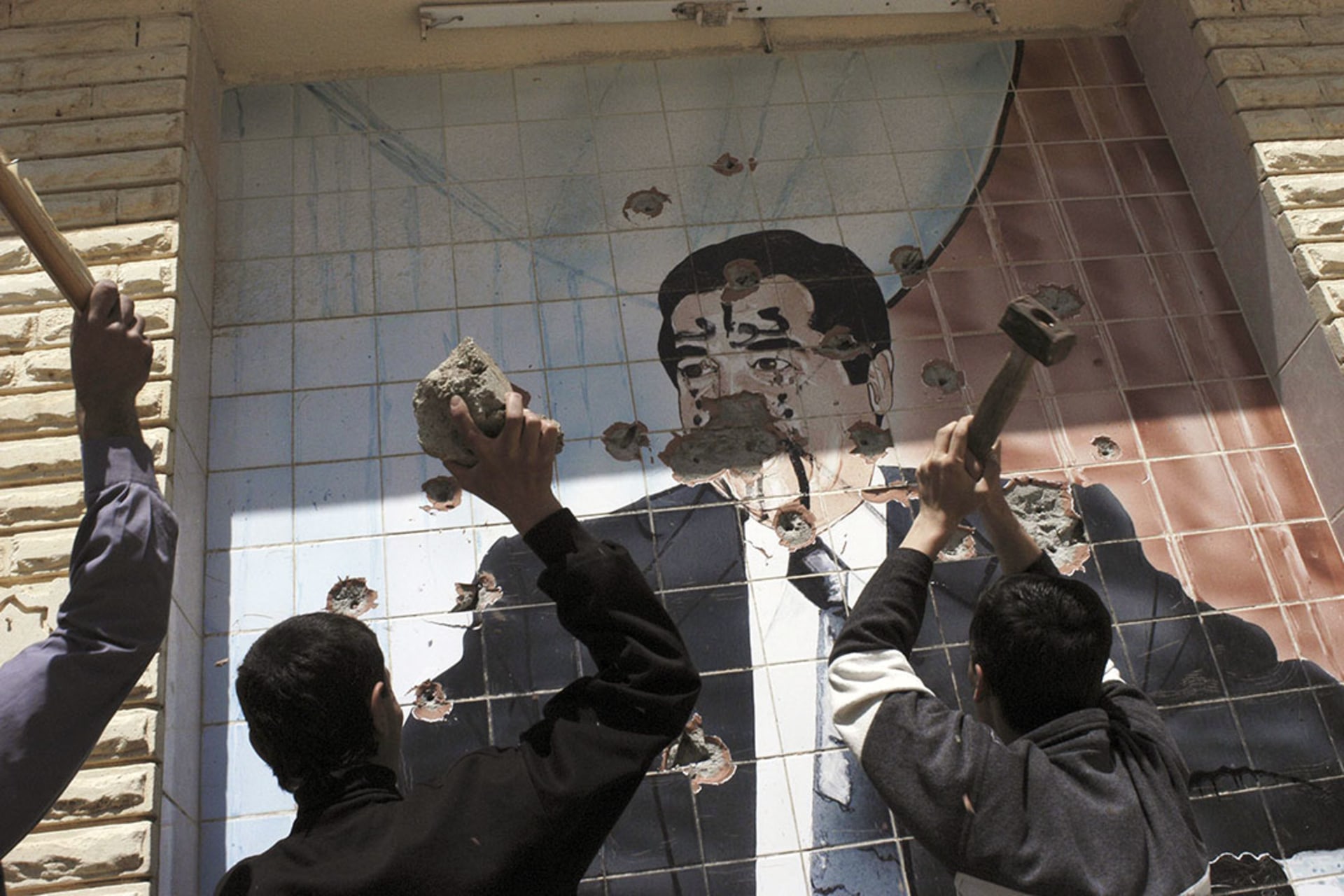 A portrait of Saddam is destroyed in Kirkuk on April 10, 2003. Kurdish troops captured the city with aid from U.S. troops during the U.S. invasion of Iraq.