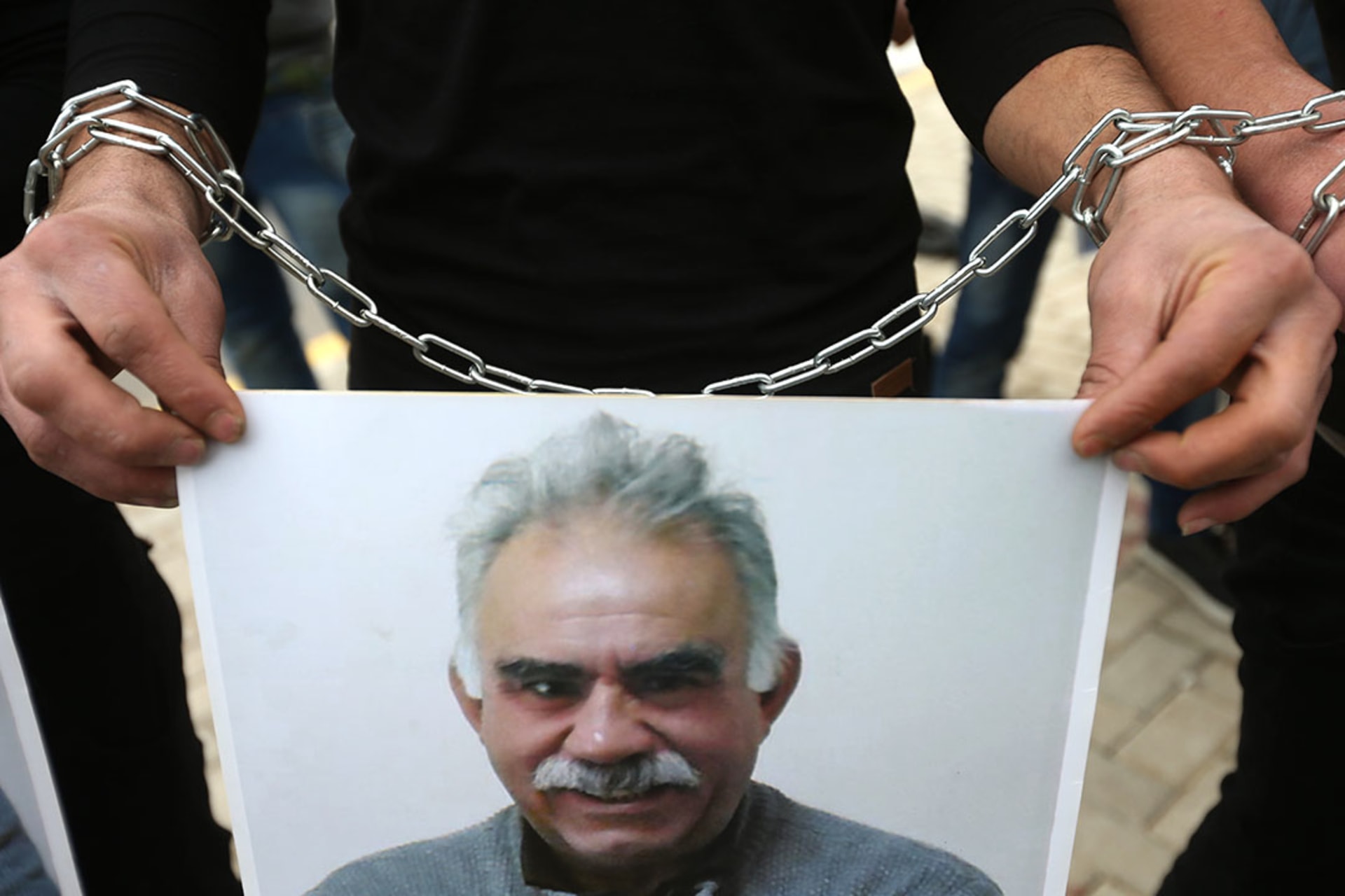 A Kurdish supporter of the PKK holds a portrait of Ocalan during a demonstration in Beirut, Lebanon.