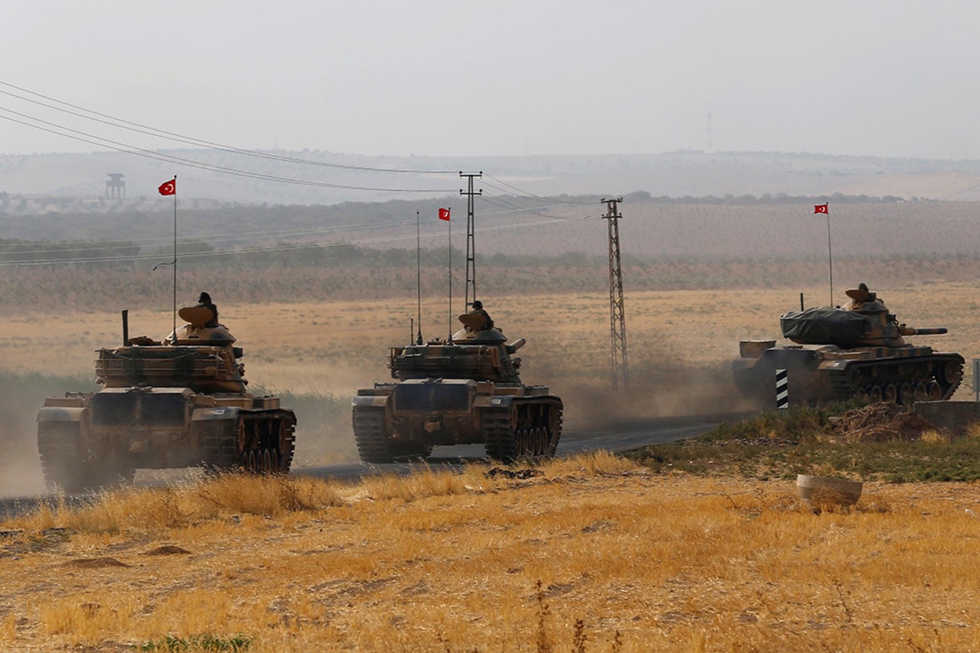 Turkish tanks drive towards the Turkish-Syrian border. 
