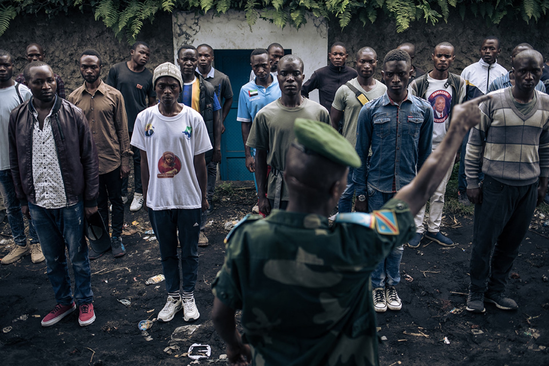 Volunteers seeking to join the DRC army stand at attention at a recruiting base in Goma in November 2022. Alexis Huguet/AFP/Getty Images