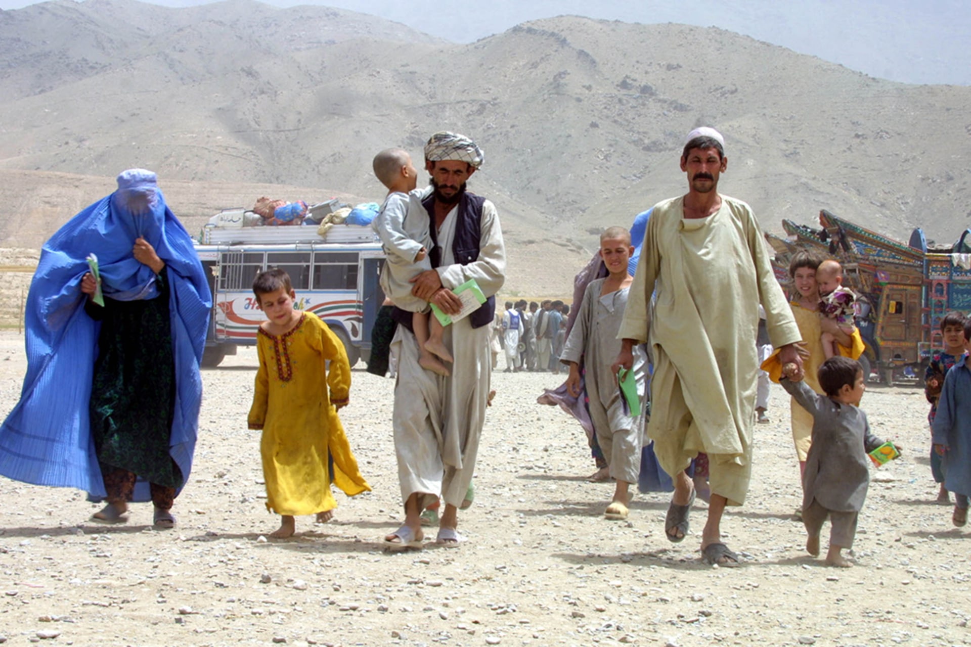 An Afghan family walks toward a refugee processing center in Pul-e-Charkhi, Afghanistan.