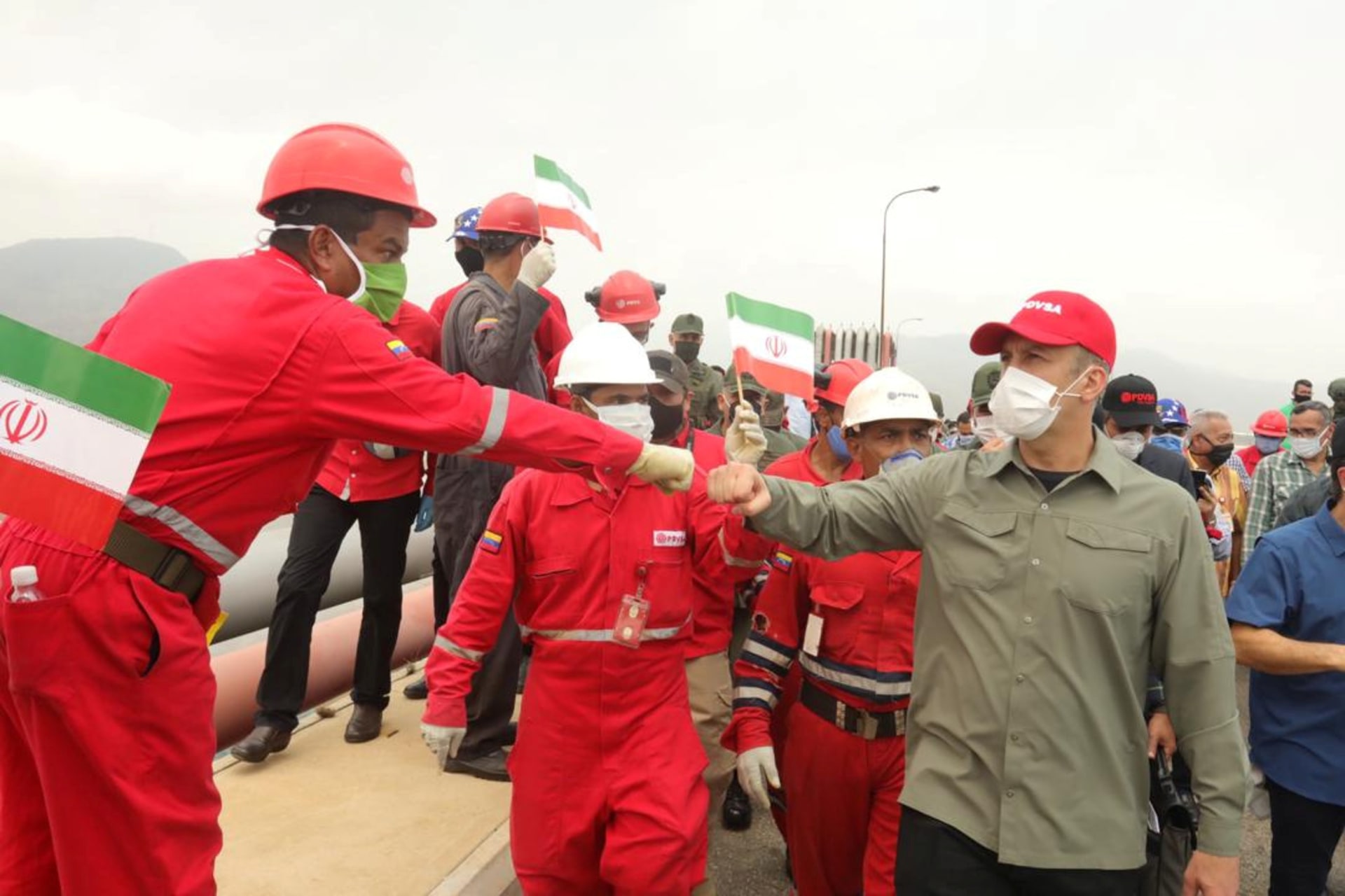 A worker from the state-owned oil company greets Venezuelan Oil Minister Tareck El Aissami as an Iranian tanker arrives in Puerto Cabello, Venezuela.