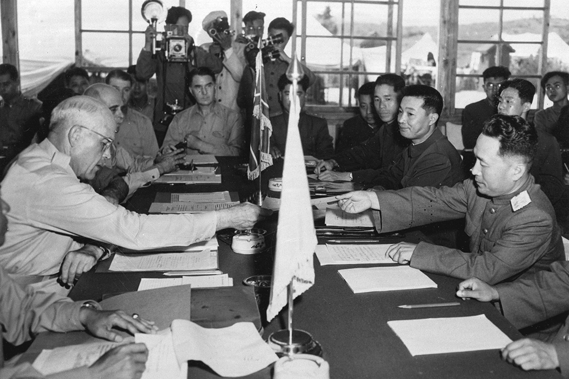 U.S. Maj. Gen. Blackshear M. Bryan exchanges credentials with Korean Communist Lt. Gen. Lee Sang Cho at the Military Armistice Commission in the Inter-Korean Peace House, situated on the south side of demilitarized zone. AP Photo