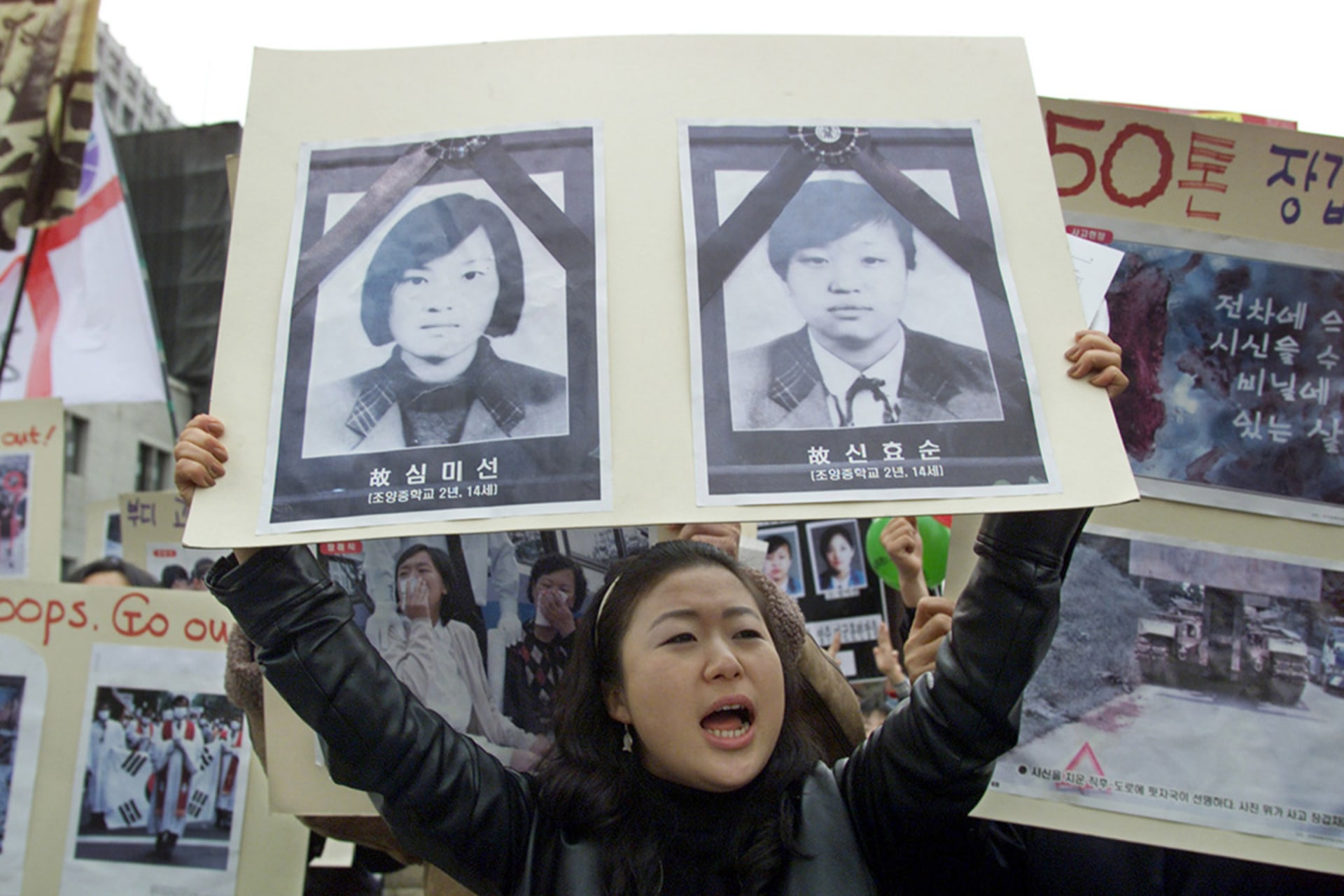 A protester shouts anti-American slogans while holding a poster of the two students accidentally killed by U.S. officers in Seoul, South Korea, on December 3, 2002. Lee Jae-Won/Reuters