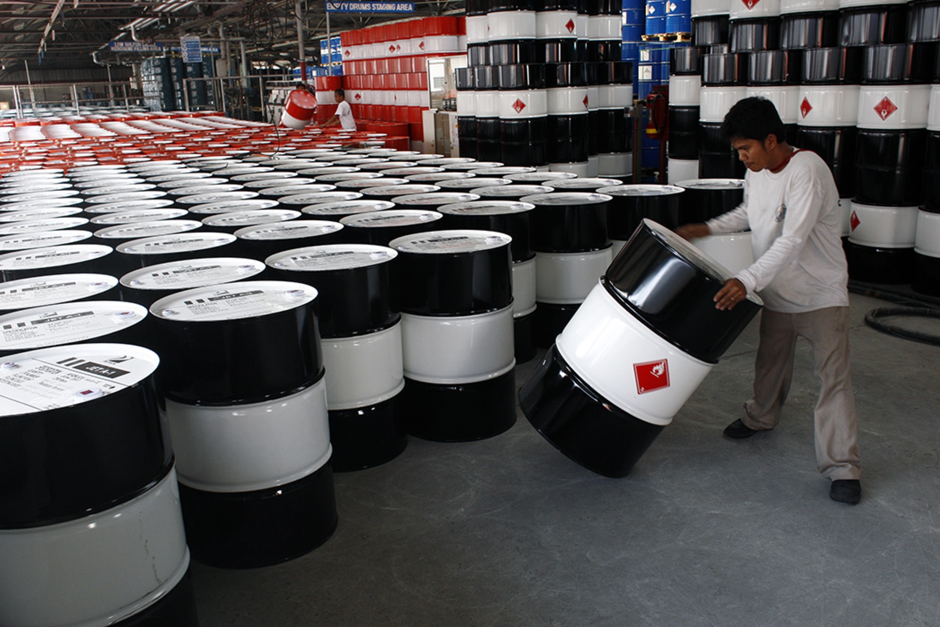 An employee of Petron Corp, the Philippines' largest oil refiner, prepares empty fuel drums. Darren Whiteside/Reuters
