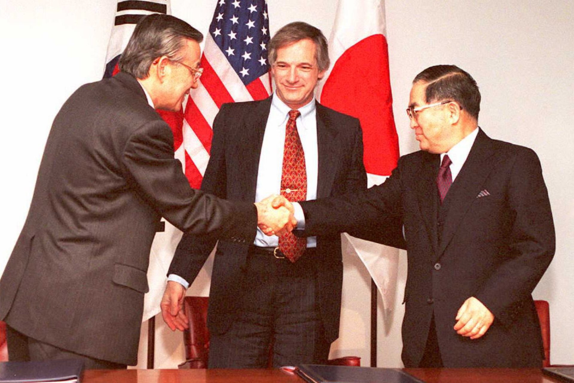 Representatives of Japan, South Korea, and the United States sign the KEDO treaty. Jon Levy/AFP via Getty Images