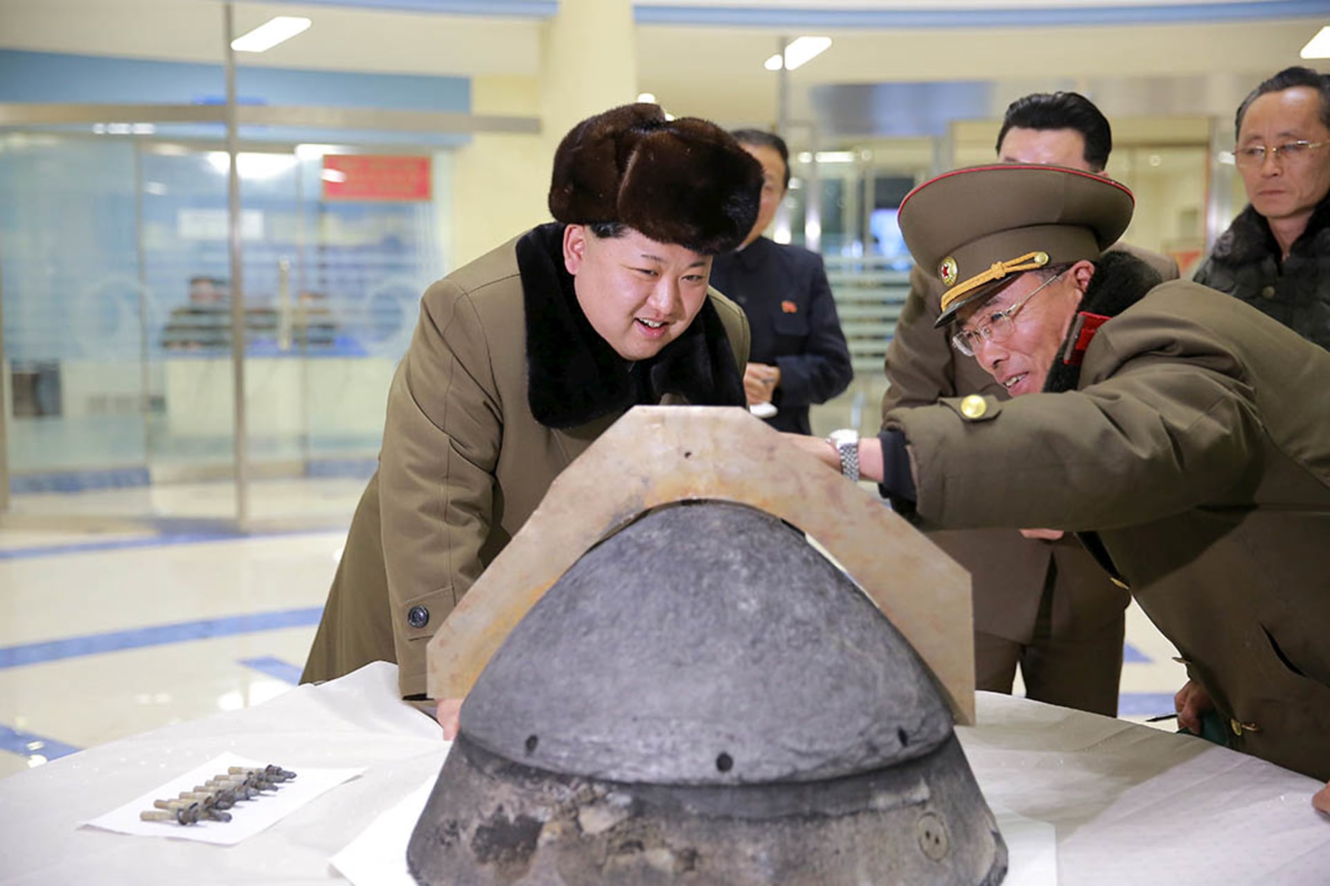 Kim Jong-un inspects the tip of a rocket warhead. KCNA/Reuters