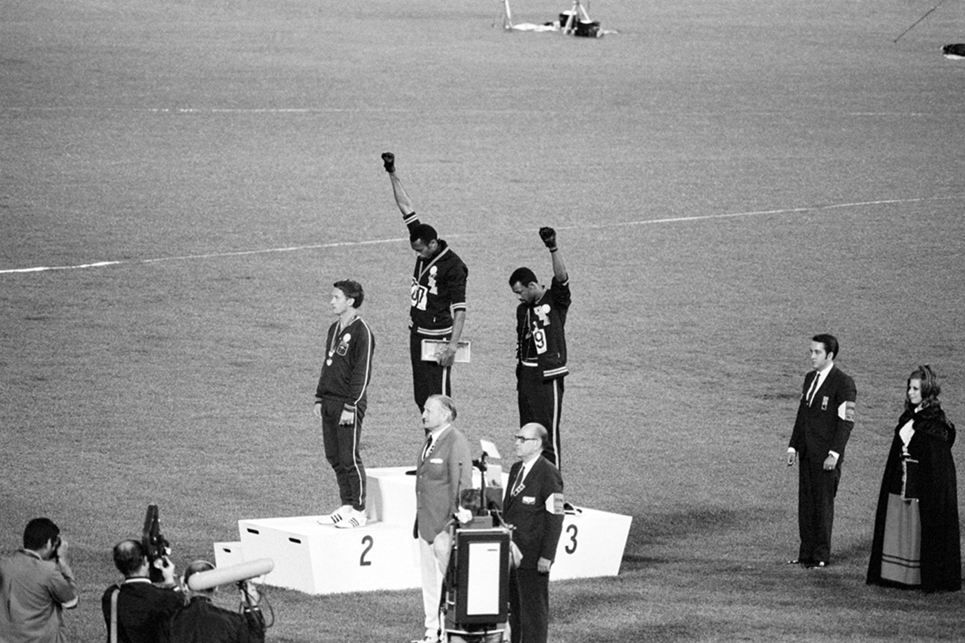 During Mexico City games, Tommie Smith and John Carlos protest the racist treatment of Black people in the United States. Bettmann/Getty Images