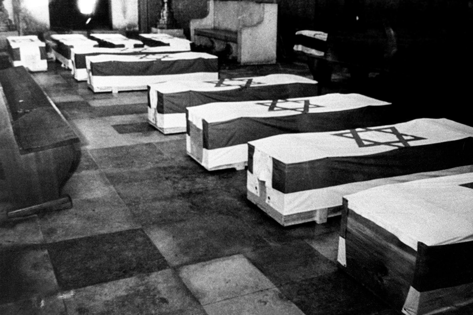 The remains of the athletes and coaches killed during the 1972 games are covered with Israeli flags and laid in a synagogue in Munich, Germany. dpa/picture alliance/Getty Images