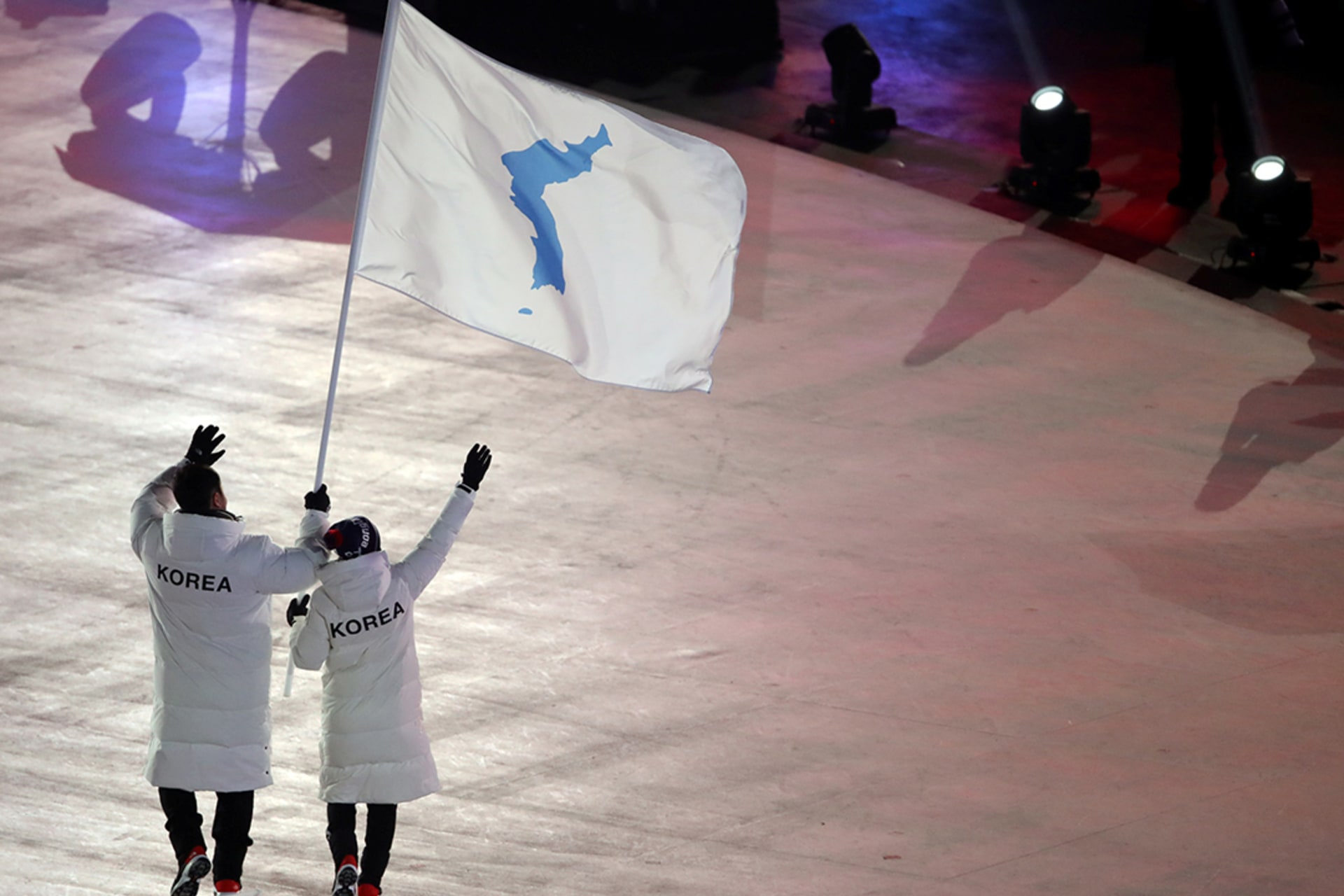 North Korean hockey player Hwang Chung-gum and South Korean bobsledder Won Yun-jong wave a flag showing the Korean Peninsula during the games in Pyeongchang, South Korea. Sean M. Haffey/Reuters