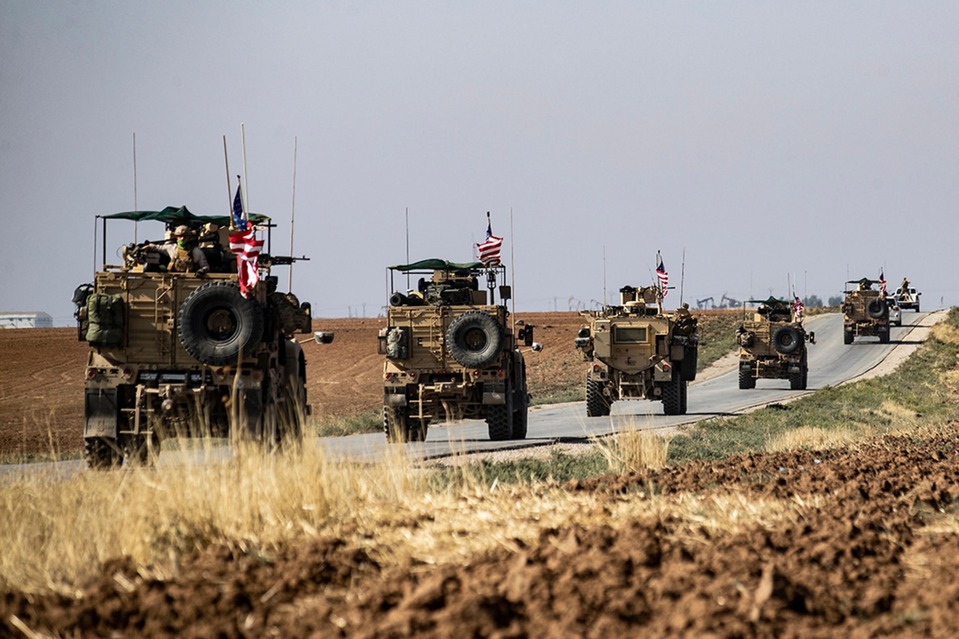 A convoy of U.S. armored vehicles patrols a stretch of the Syria-Turkey border in October 2019. Delil Souleiman/AFP/Getty Images