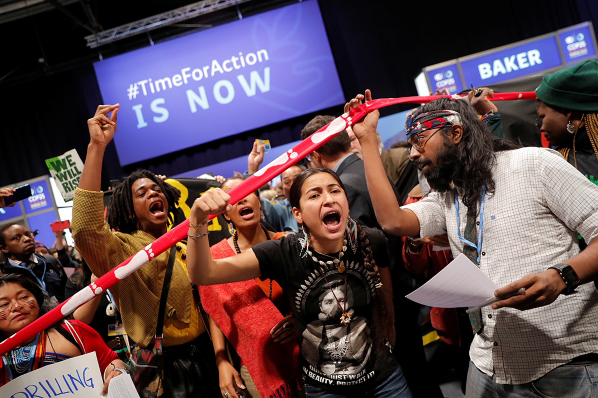 Climate activists chant outside a conference room at COP25 in Madrid. Susana Vera/Reuters