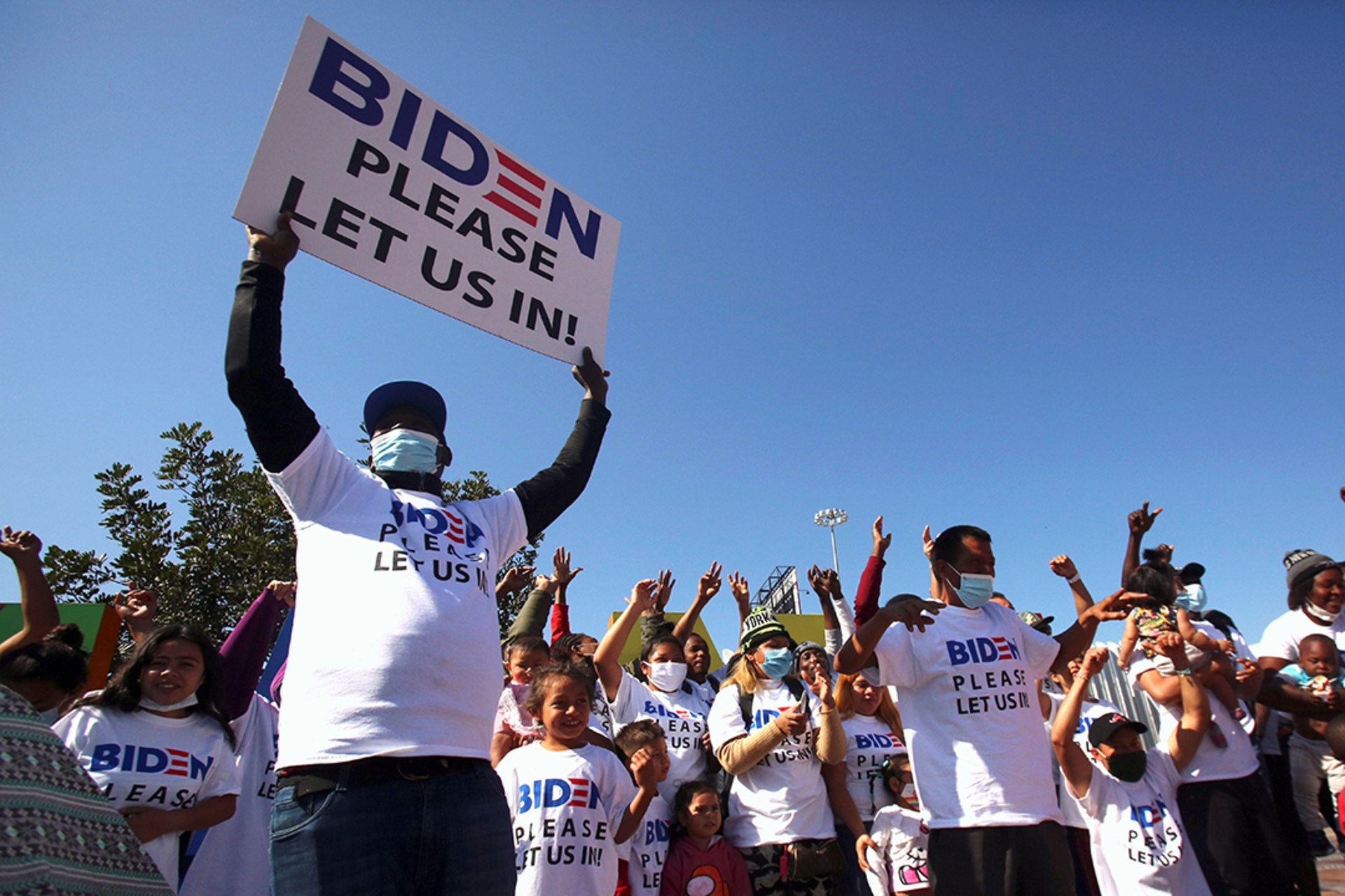Latin American migrants call on U.S. President Joe Biden to grant them asylum from their campsite outside the El Chaparral border crossing in Tijuana, Mexico, in February 2021. Jorge Duenes/Reuters