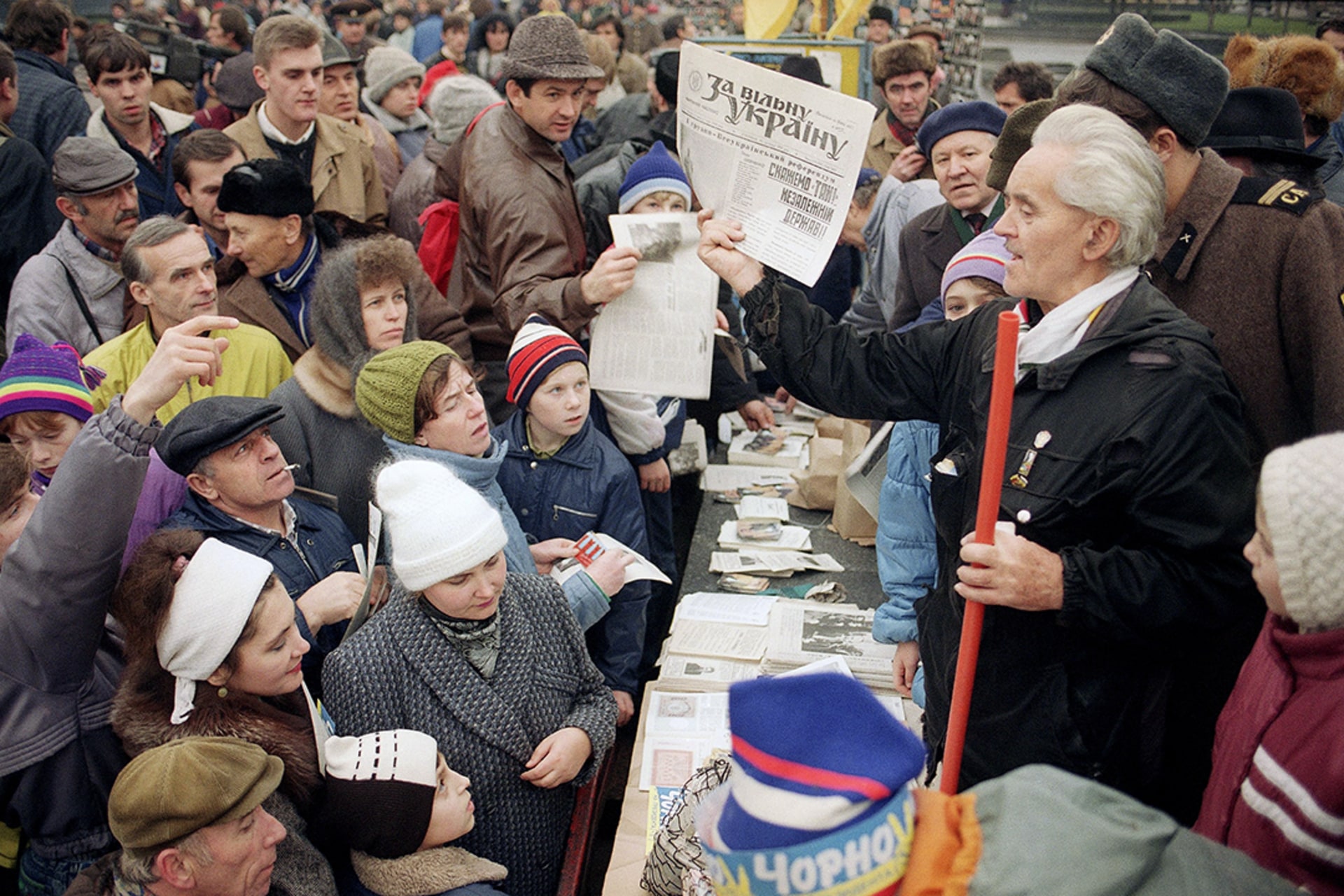 A campaign worker speaks to a crowd at a campaign stand in Kyiv.
