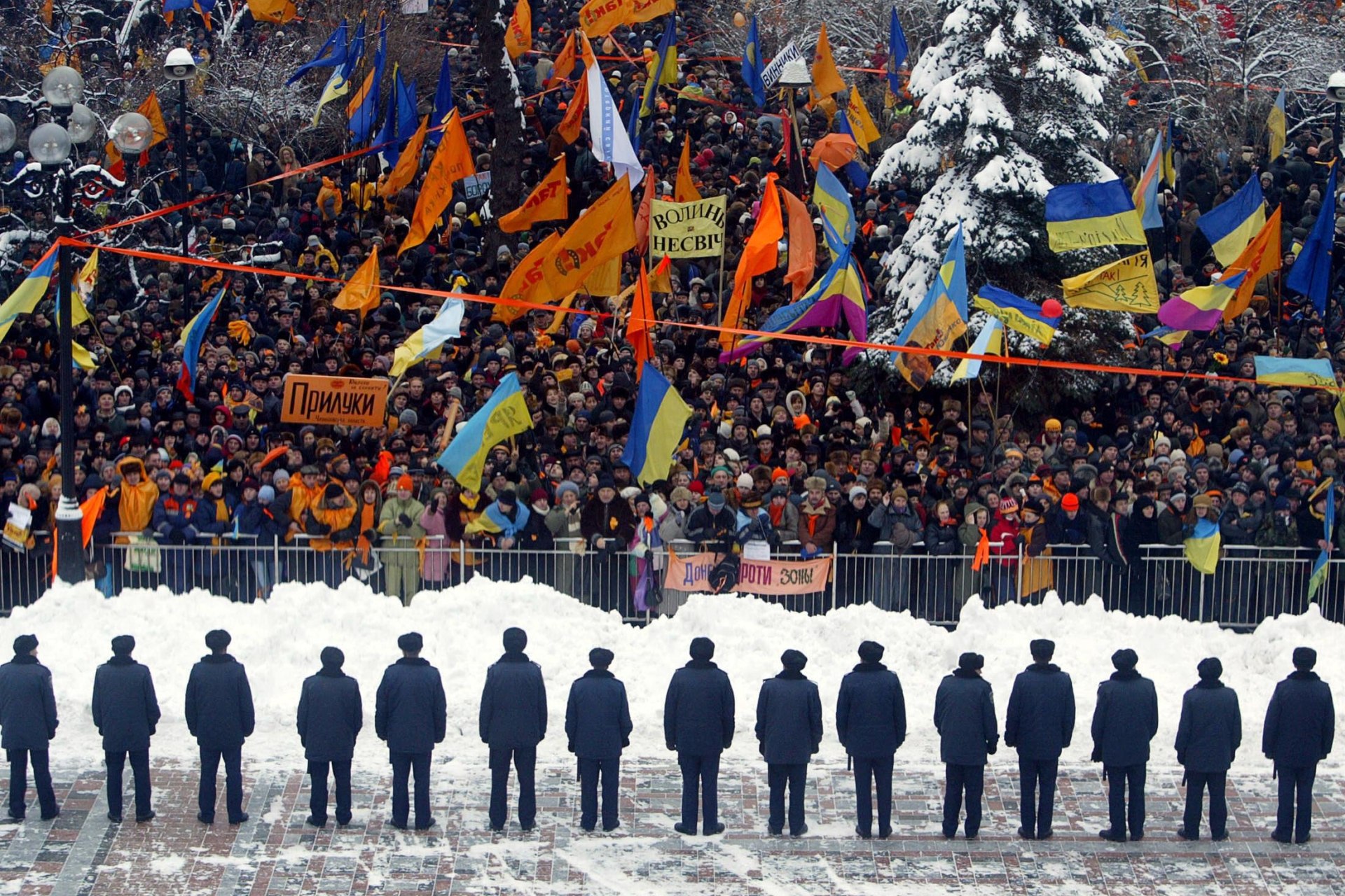 Police guard the parliament building in Kyiv as it is surrounded by opposition supporters. 
