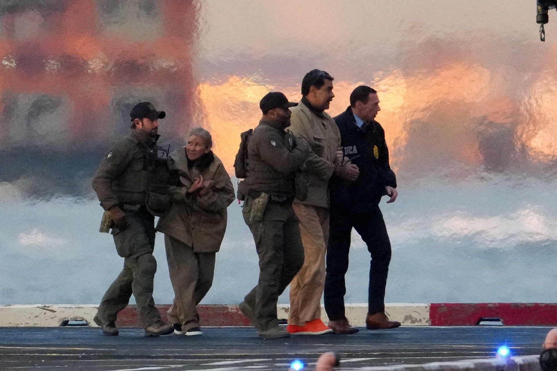 Law enforcement officials move captured Venezuelan President Nicolas Maduro as he heads for an initial appearance to face U.S. federal charges in New York City, U.S., January 5, 2026. 