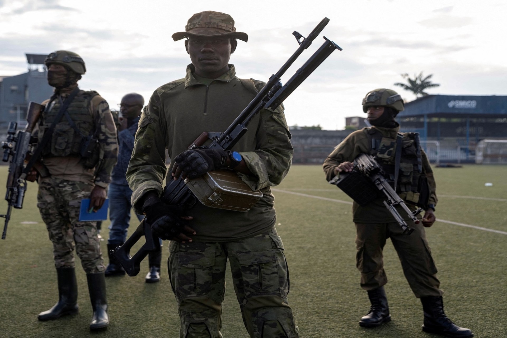 <p>M23 rebels stand guard where captured members of the armed forces of the Democratic Republic of the Congo and Wazalendo troops wait to be taken aboard trucks for training, in Goma, North Kivu, Democratic Republic of Congo, May 10, 2025.</p>
