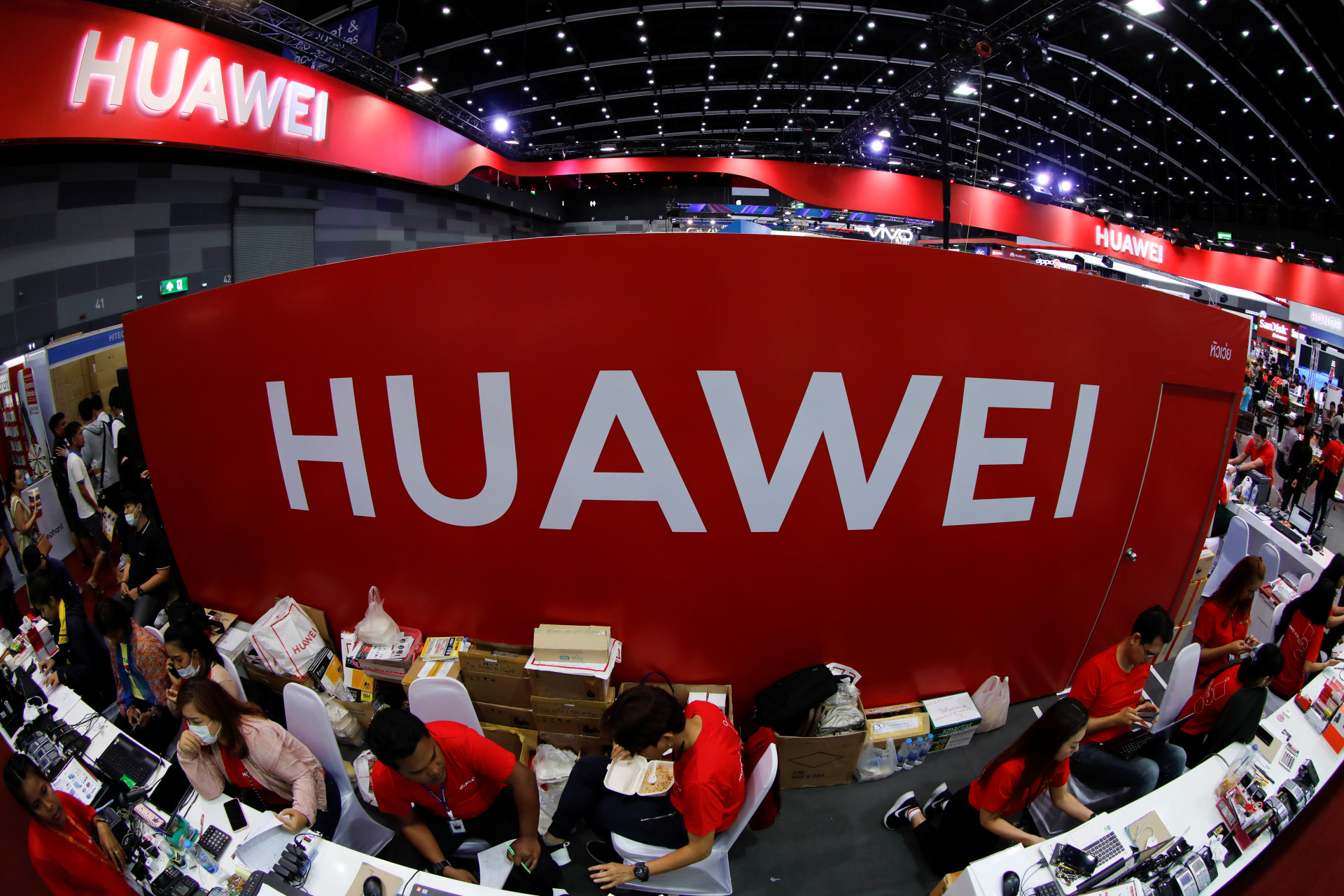 <p>Workers sit at the Huawei stand at the Mobile Expo in Bangkok, Thailand, May 2019</p>
