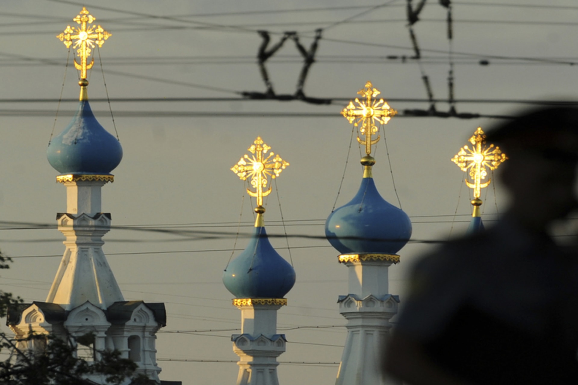 A Russian policeman passes an Orthodox church during a demonstration to support political prisoners in Moscow