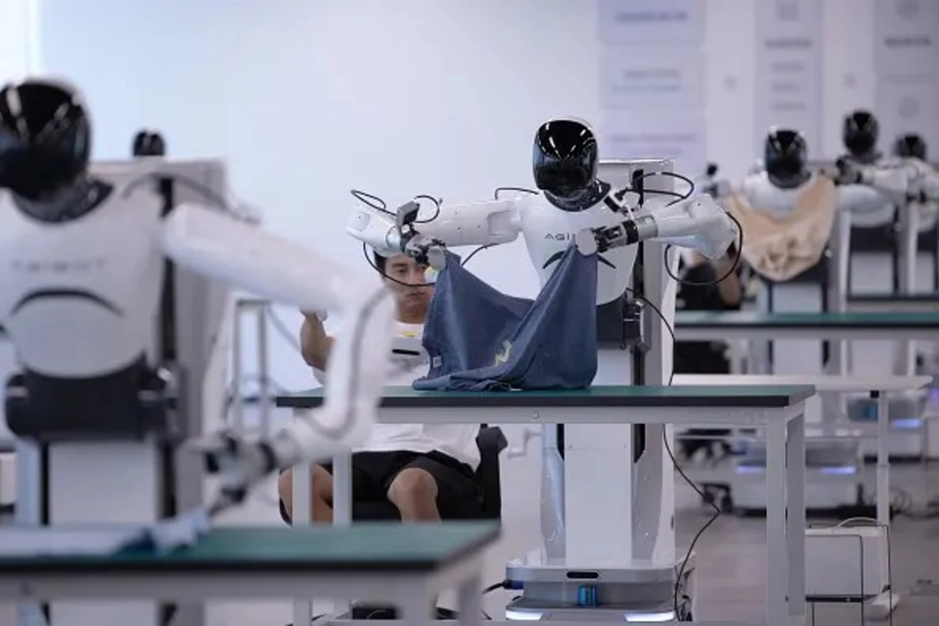 <p>Humanoid robots follow technicians to learn job skills at the data collection area of an embodied AI robot innovation center on September 14, 2025, in Shaoxing, in China’s Zhejiang province.</p>