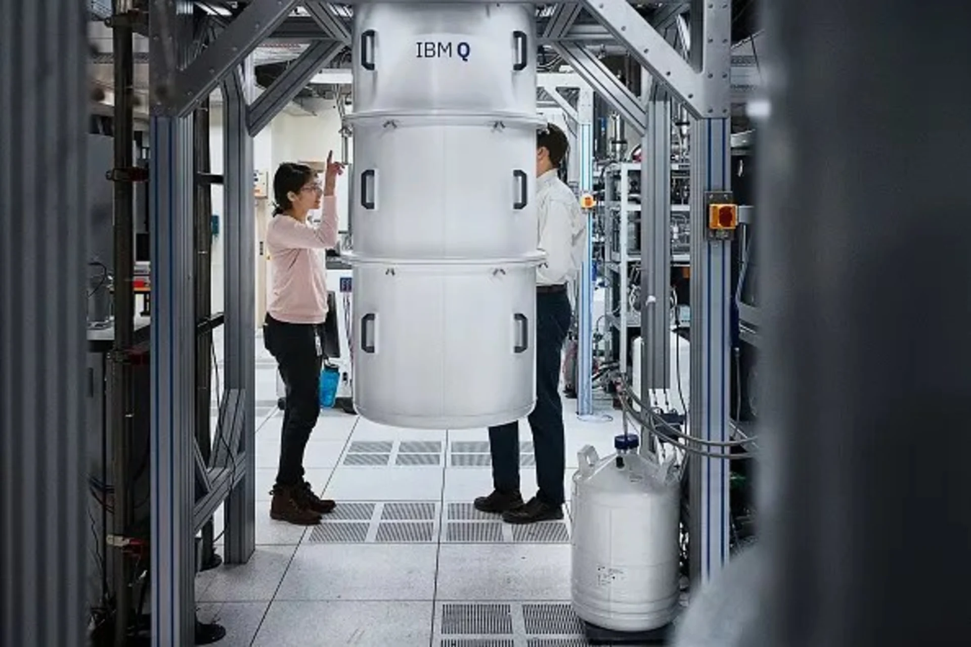 <p>IBM Research team members stand next to the IBM Q System One quantum computer in October 2019 at IBM’s research facility in Yorktown Heights, New York.</p>